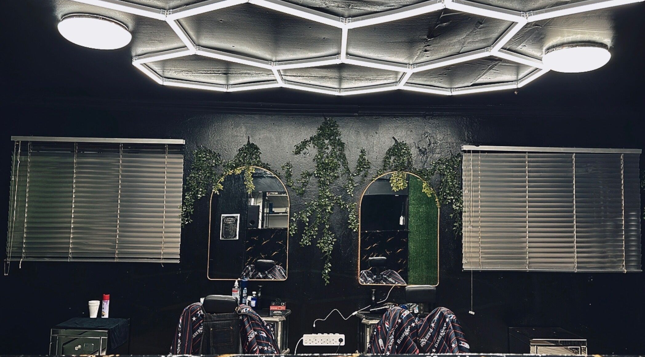Chic interior of X-Barber in Soweto, Gauteng, ZA with stylish mirrors and elegant lighting.