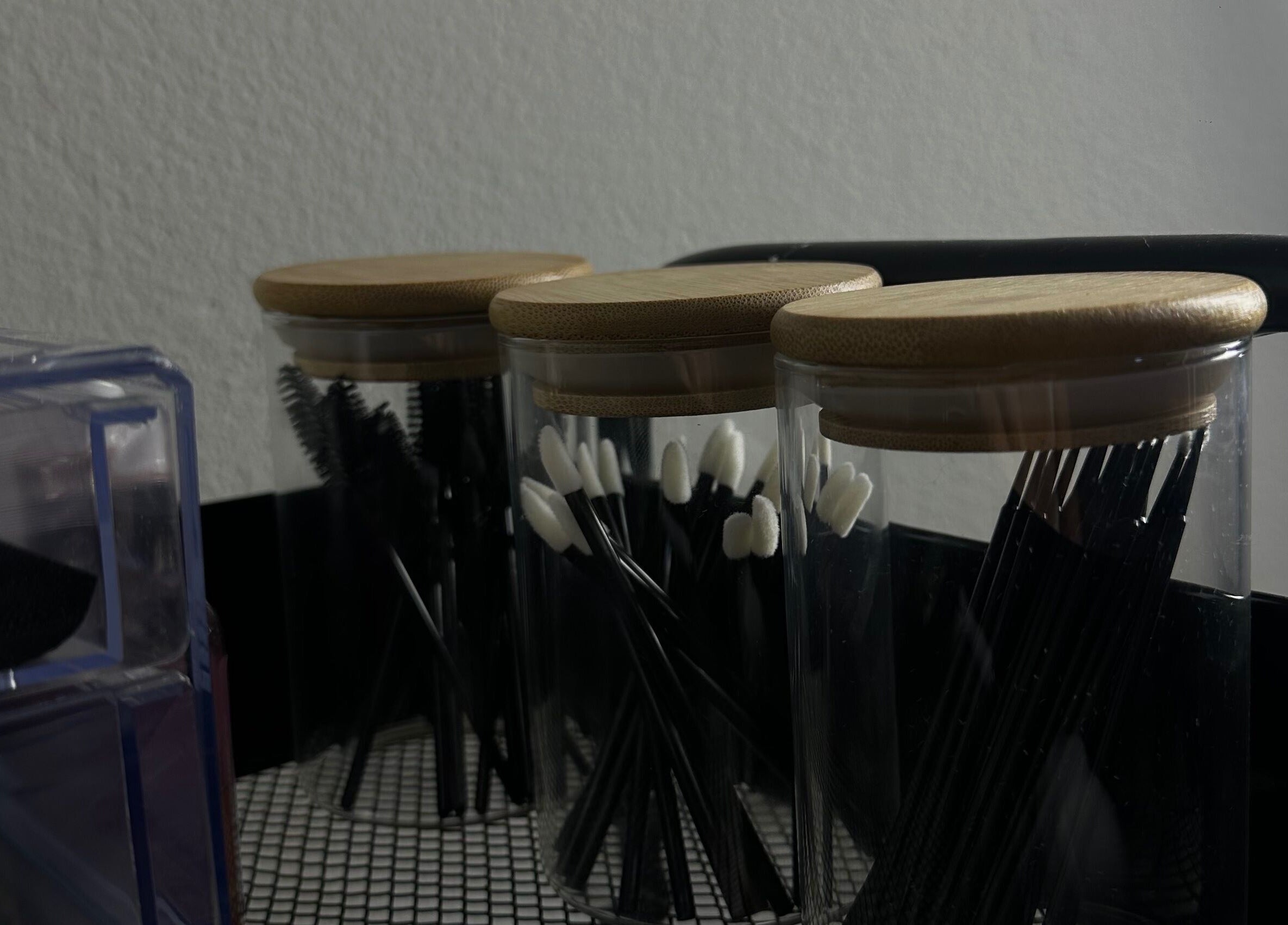 Beauty tools in jars at Wilashes, Lima, Provincia De Lima, PE, showcasing elegance and organization.