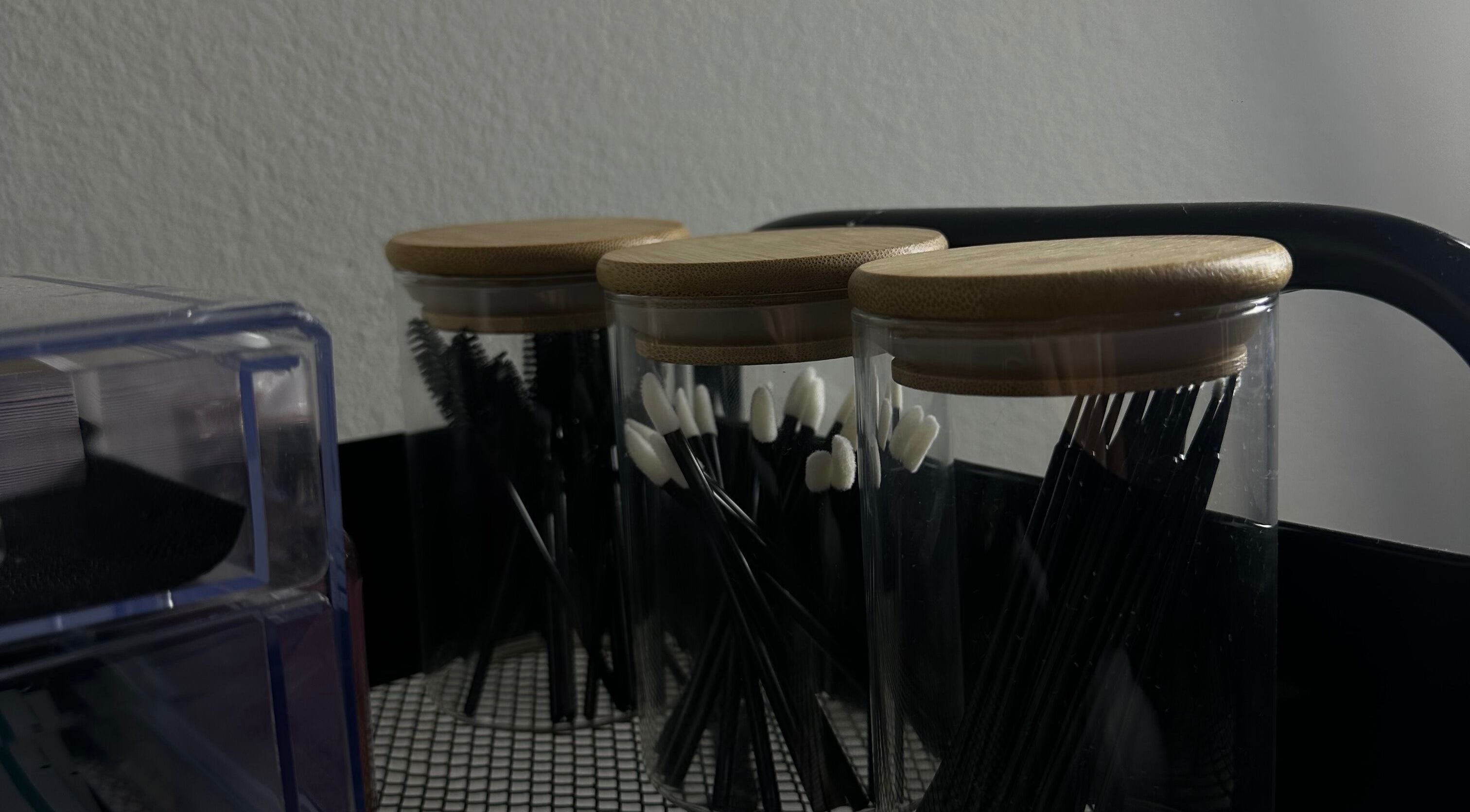 Beauty tools in jars at Wilashes, Lima, Provincia De Lima, PE, showcasing elegance and organization.