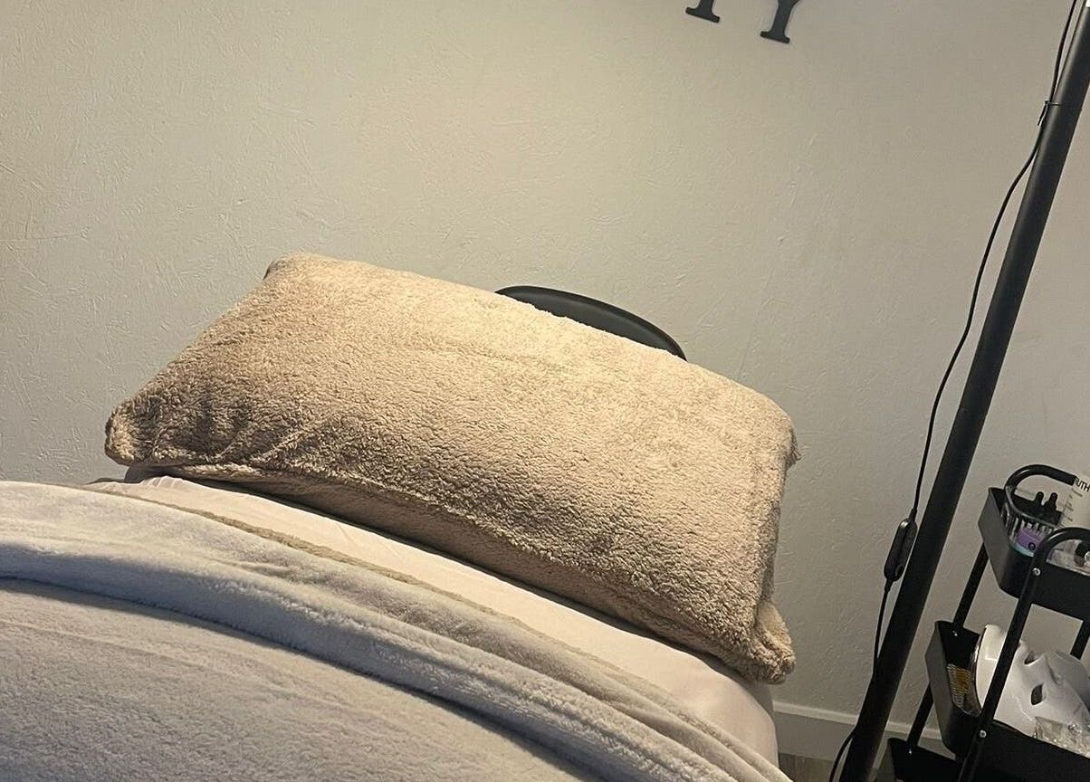 Relaxing treatment room at Raine Beauty, Birmingham, England, GB with a cushioned table and wellness equipment.