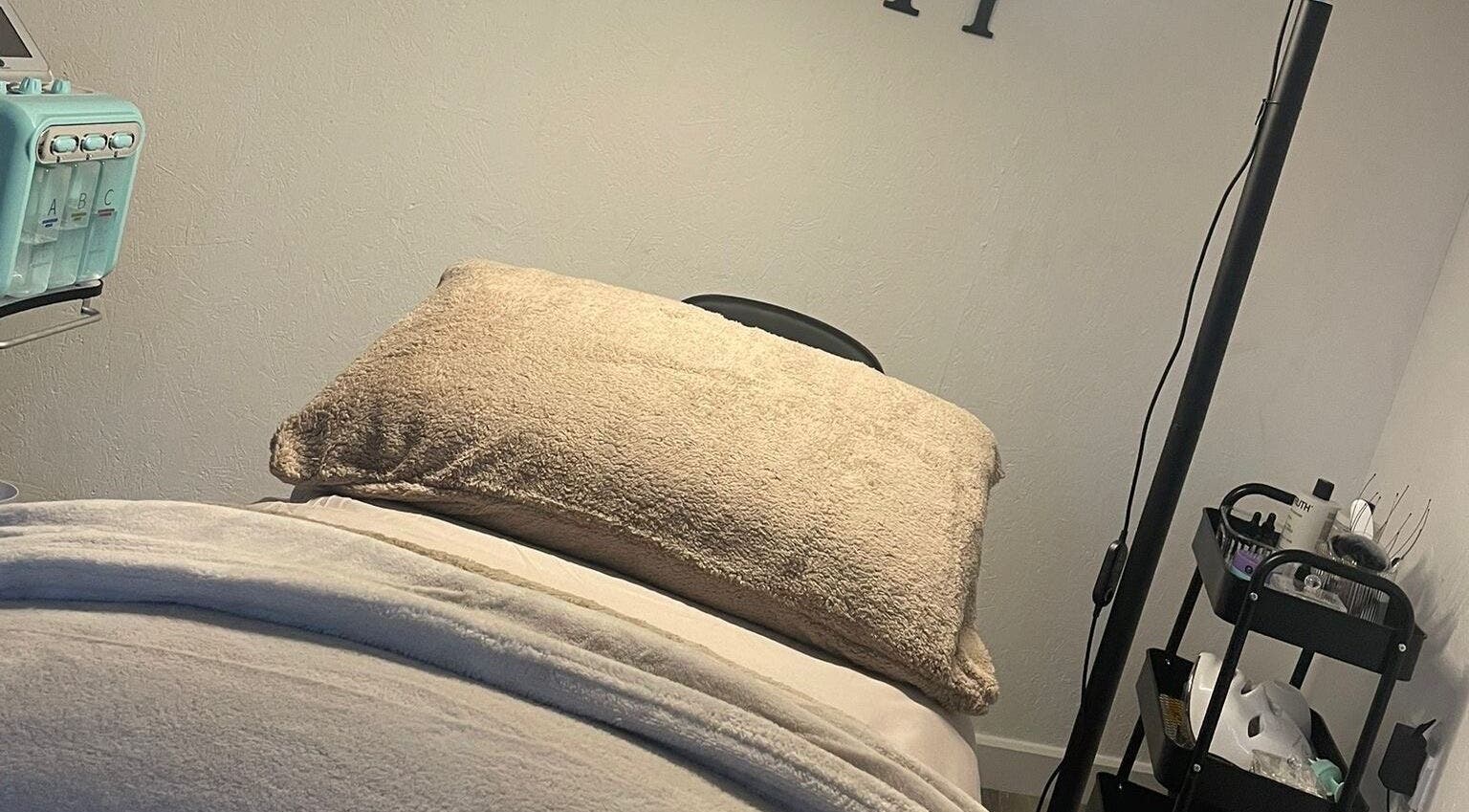 Relaxing treatment room at Raine Beauty, Birmingham, England, GB with a cushioned table and wellness equipment.