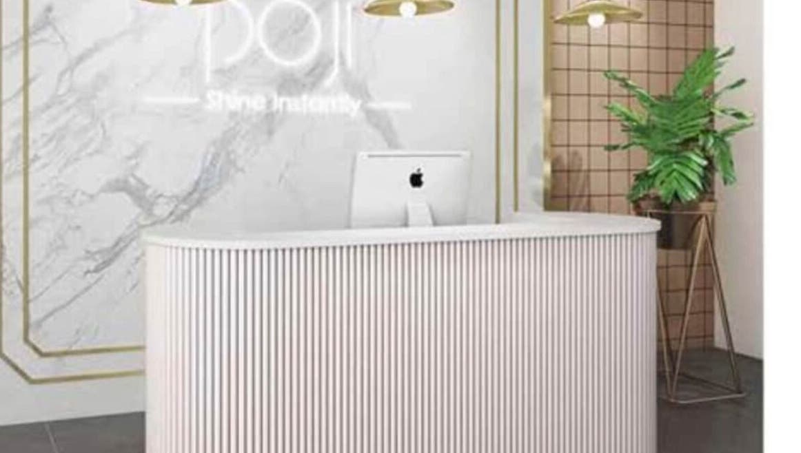 Elegant reception at Cecilianahair, Manchester, England, GB with modern decor and lush plant.