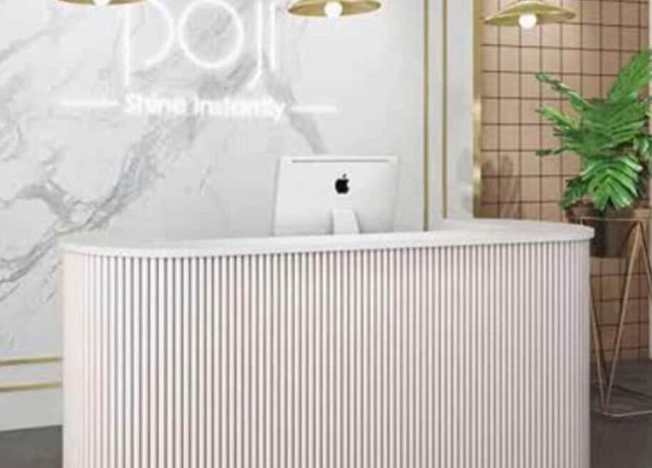 Elegant reception at Cecilianahair, Manchester, England, GB with modern decor and lush plant.