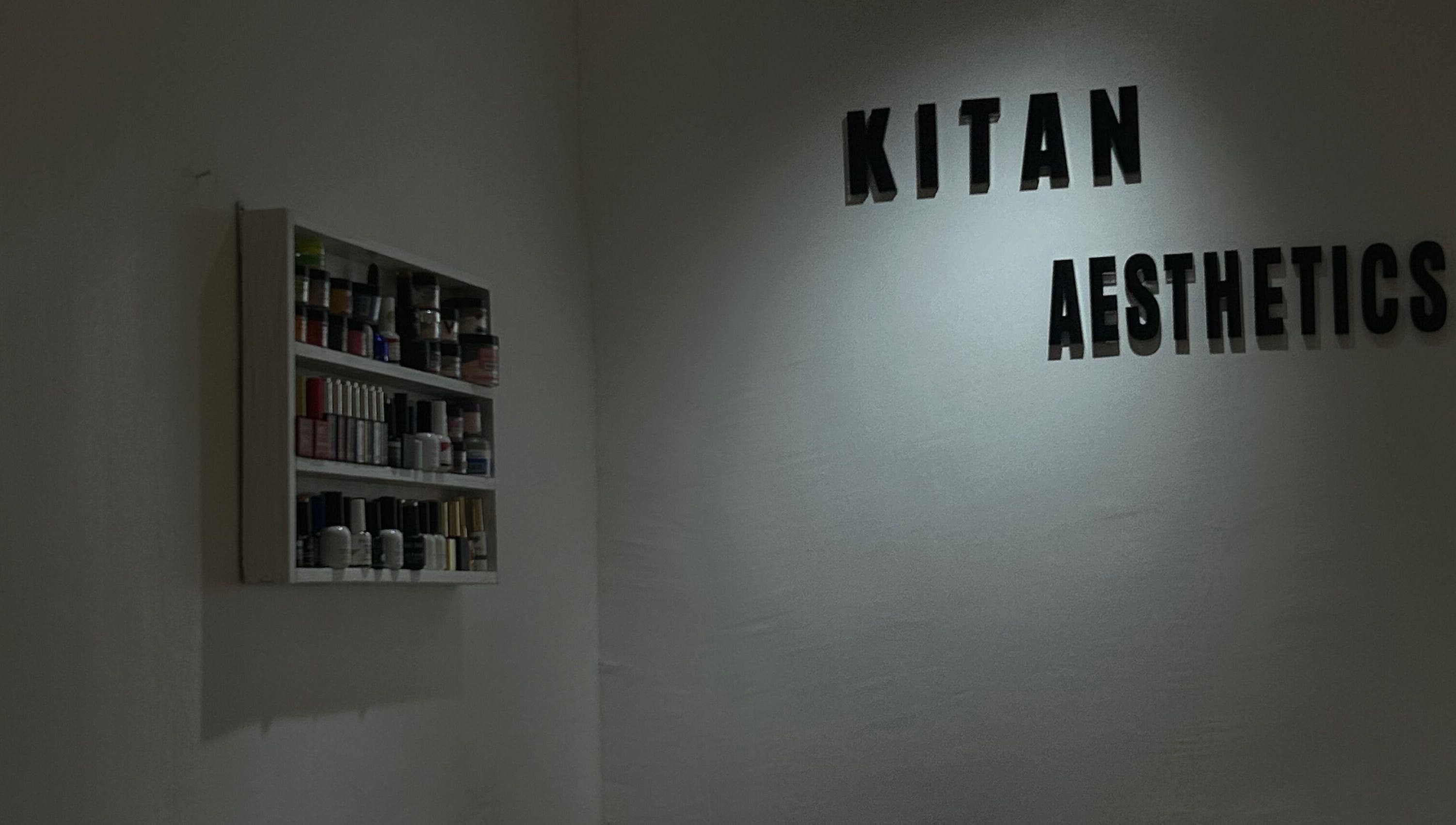 Minimalist shelving and 'Kitanaesthetics' wall decor in Lagos, Lagos, NG beauty and wellness venue.