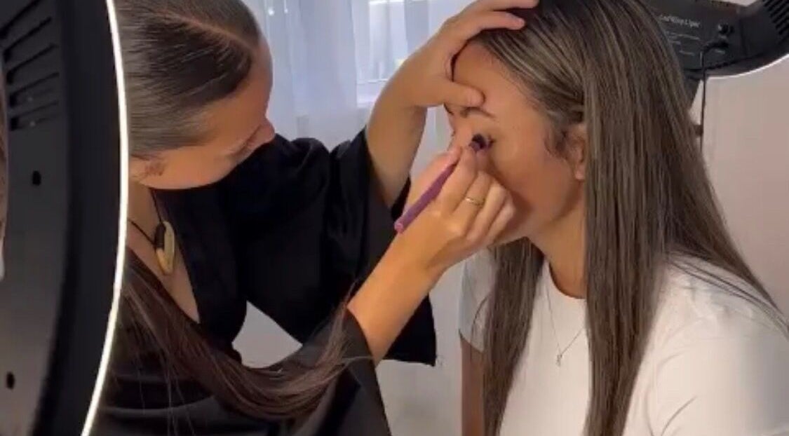 Makeup artist skillfully applying eye makeup at Ashleigh-Rose MUA, Falcon, Western Australia, AU.