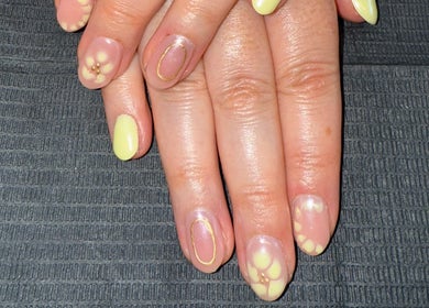 Elegant floral nail art at Nails By SHTB in Wick, Scotland, GB, showcasing intricate yellow designs.