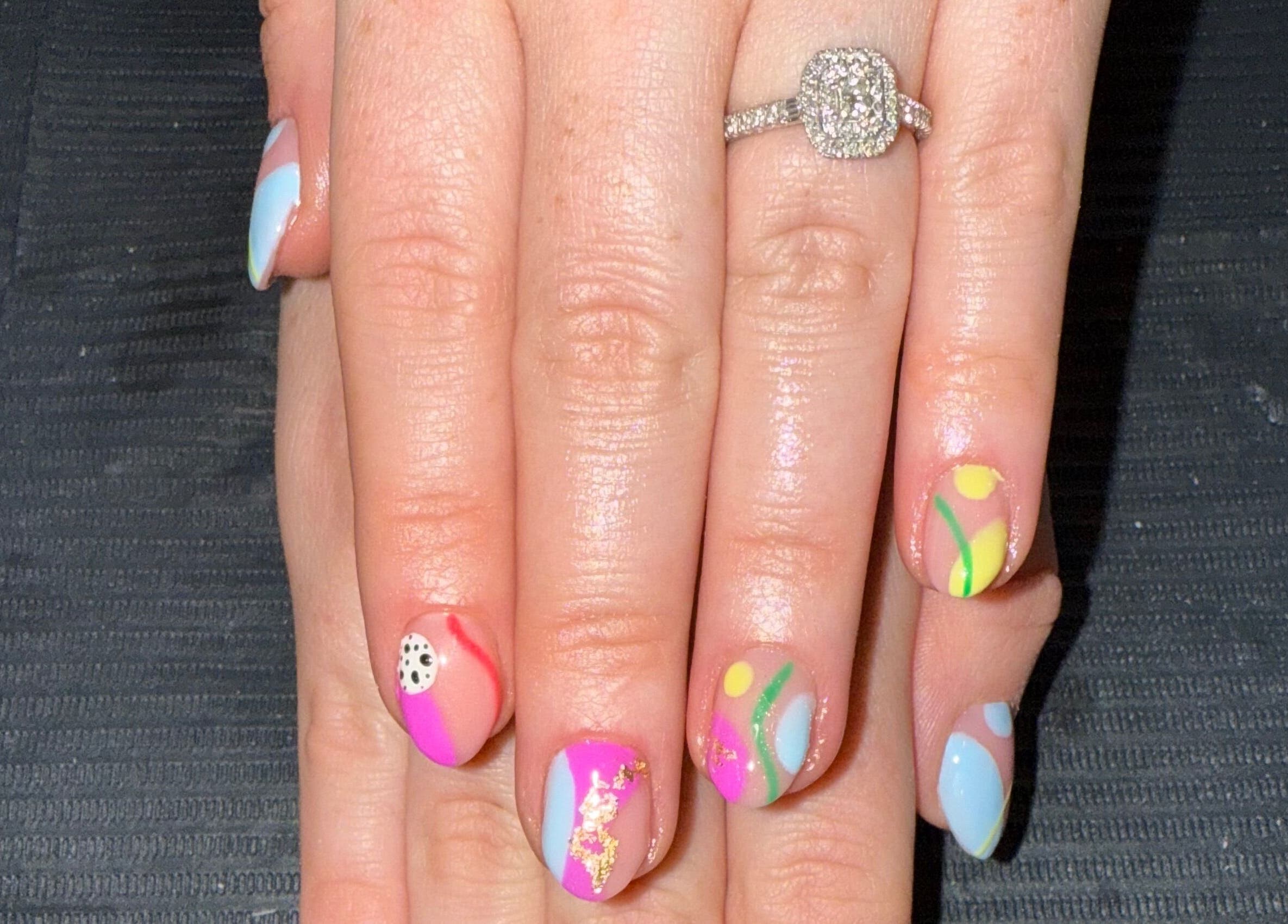 Colorful nail art at Nails By SHTB, Wick, Scotland, GB features vibrant designs and a sparkling ring.