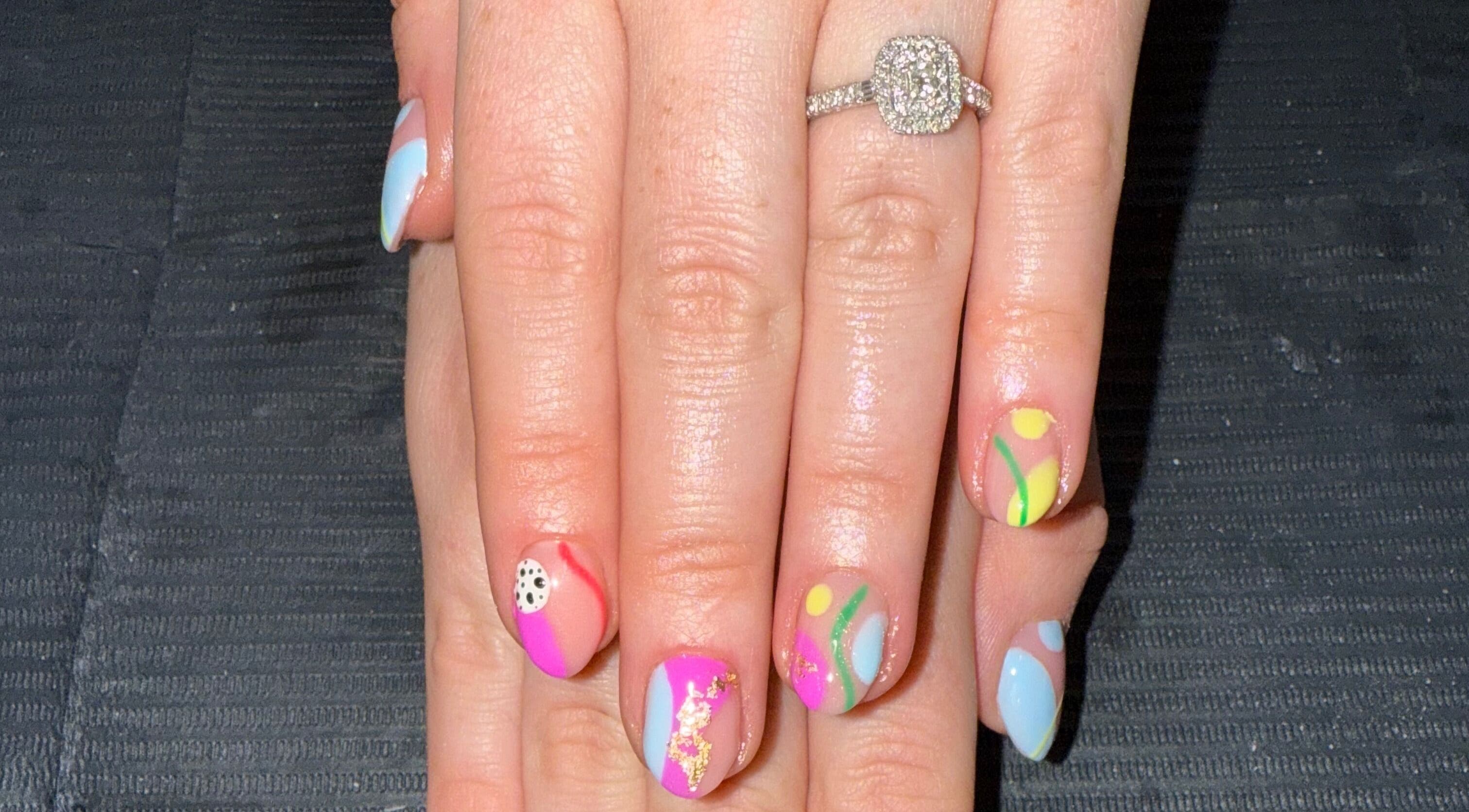 Colorful nail art at Nails By SHTB, Wick, Scotland, GB features vibrant designs and a sparkling ring.