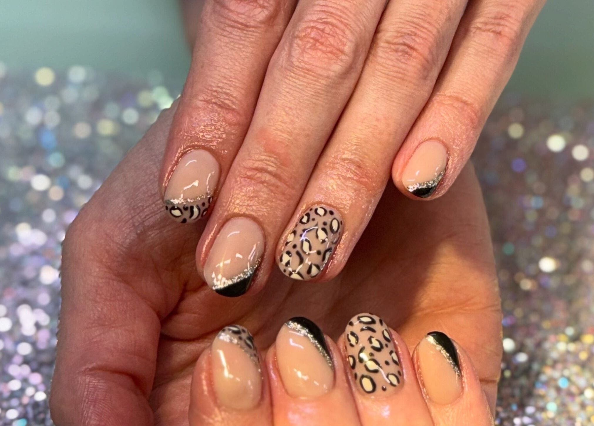 Stylish leopard nail art by Nails By SHTB, Wick, Scotland, GB, showcasing elegant black tips.