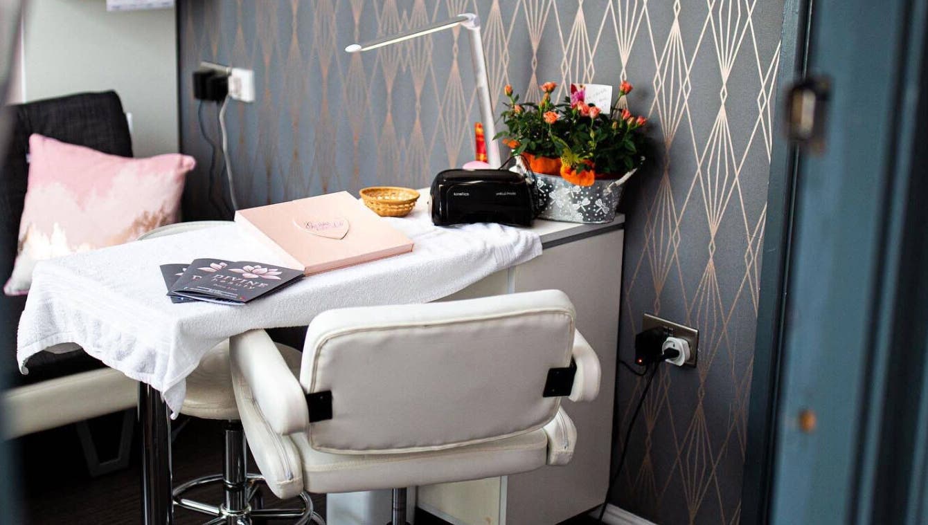 Stylish nail station at Divine Beauty Salon, Guernsey, Saint Peter Port, GG, featuring a comfortable chair and floral decor.