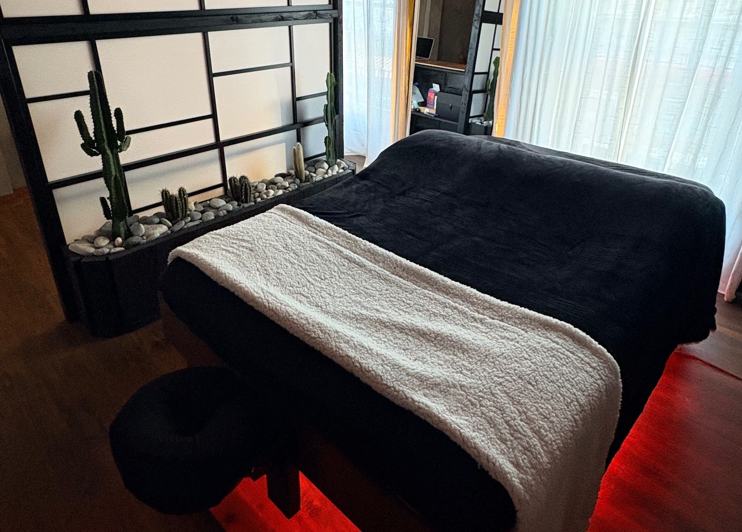 Tranquil massage room at N a n d o | Massage Therapy in Dalkey, County Dublin, IE with serene decor and soft lighting.