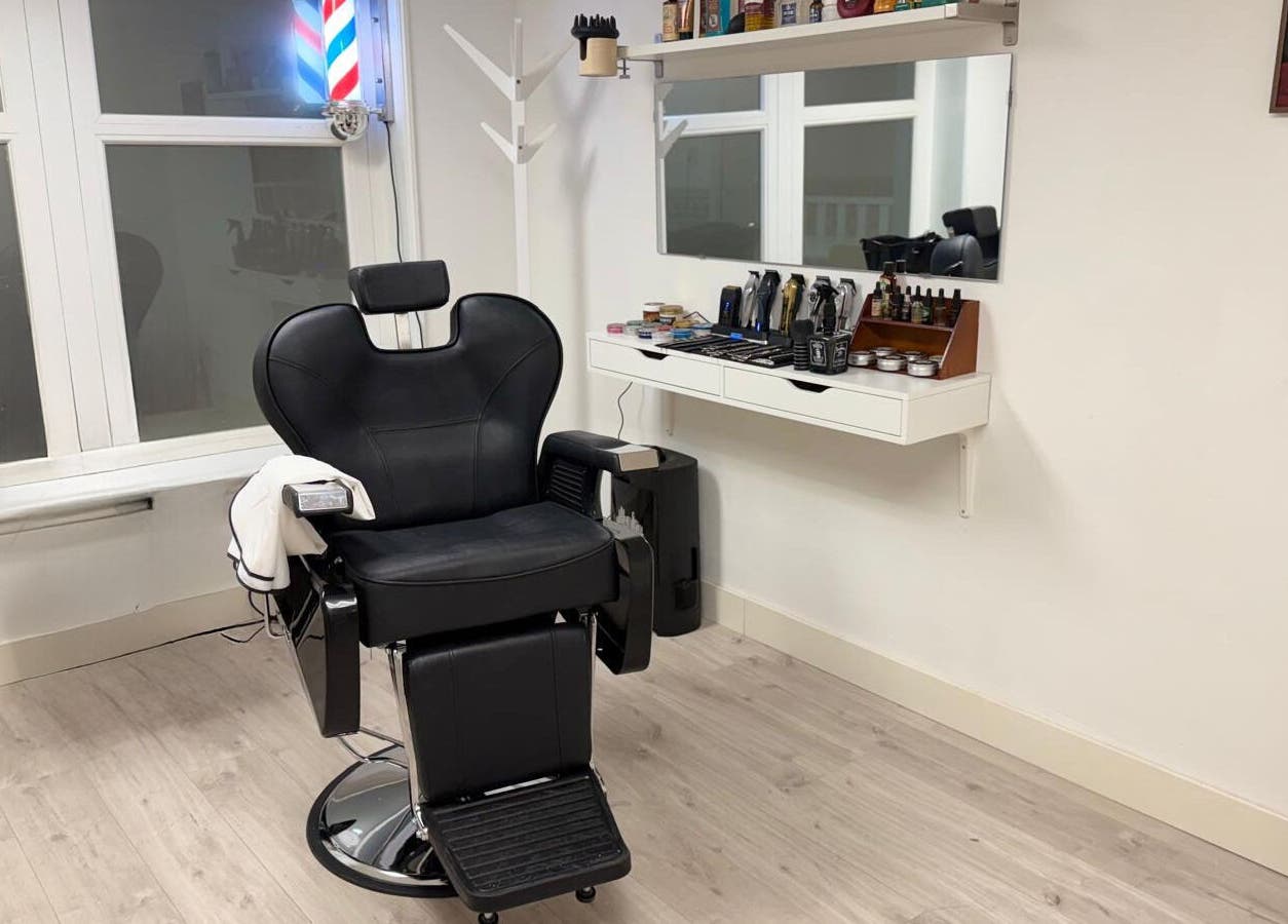 Moderne kappersstoel bij CutzByTravis in Amsterdam, Noord-Holland, NL voor ultiem comfort en stijl.