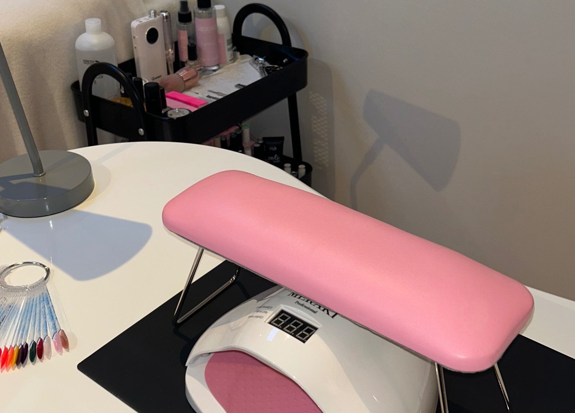Stylish nail station setup at NailingIt, Cobh, County Cork, IE featuring pink armrest and manicure tools.