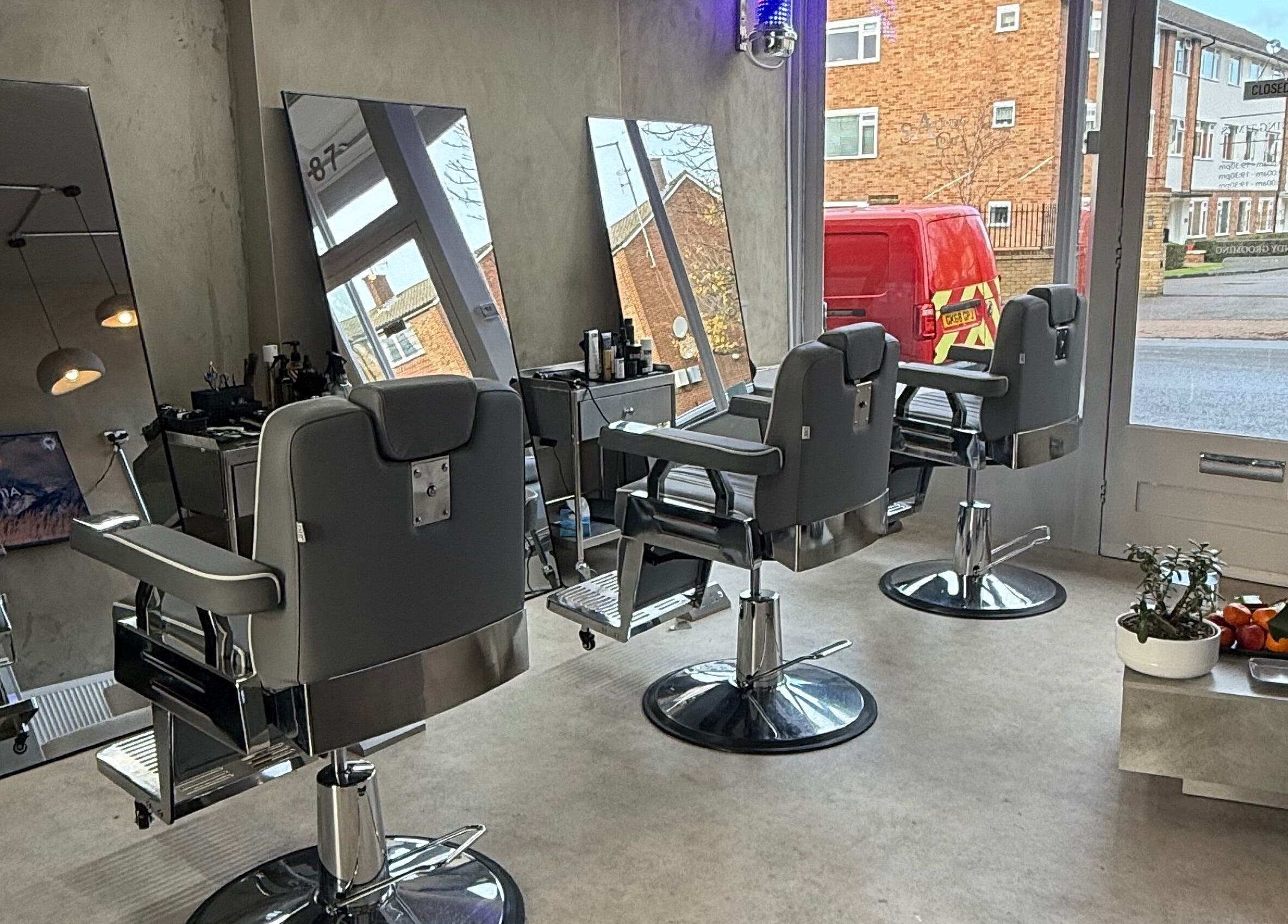 Modern interior of Mundy Grooming in London, England, GB with sleek barber chairs and mirrors.