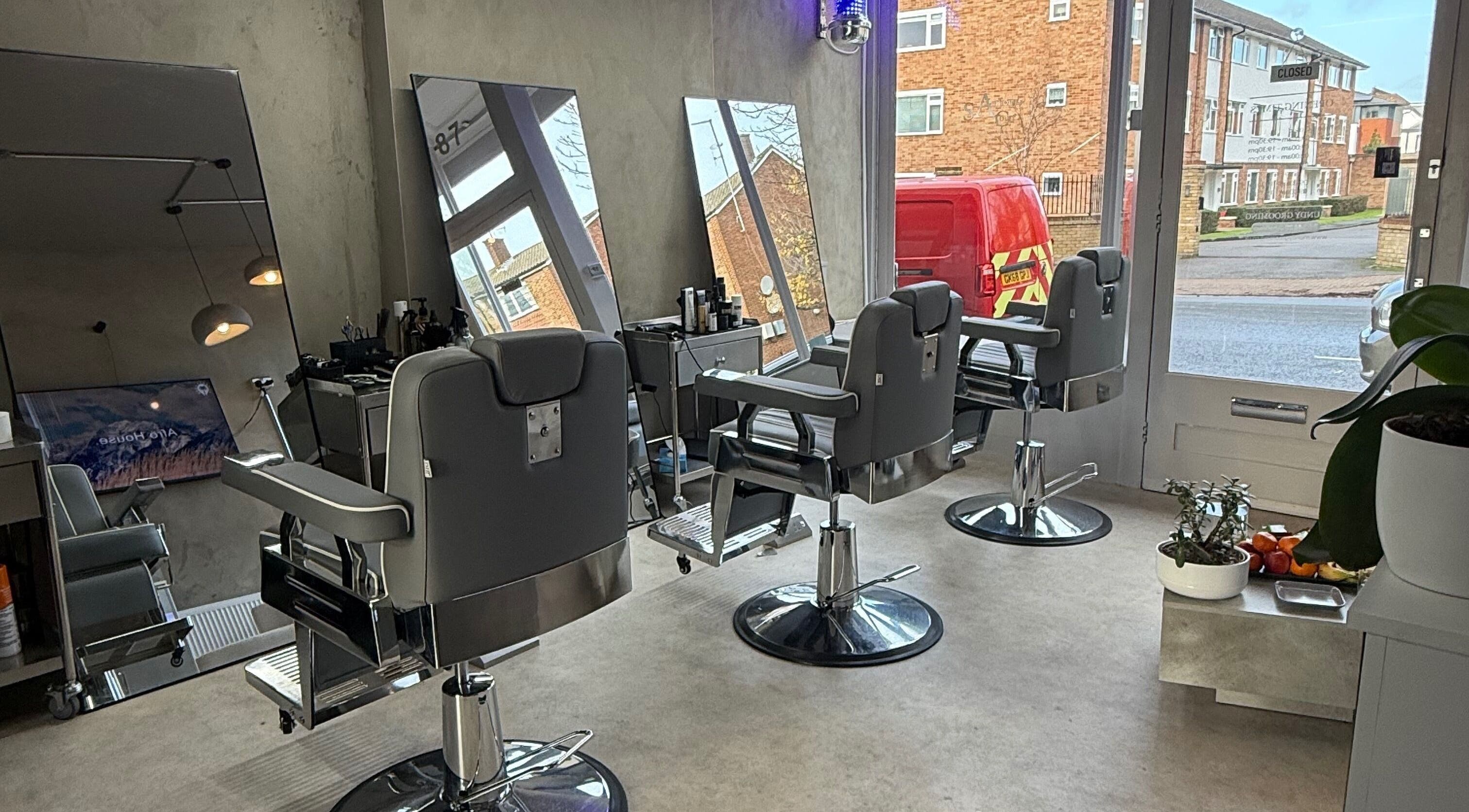 Modern interior of Mundy Grooming in London, England, GB with sleek barber chairs and mirrors.