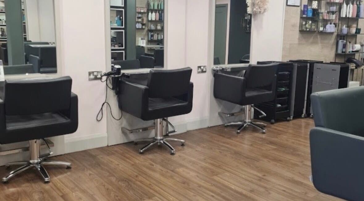 Stylish salon chairs at Blushandbrowstudio, Dublin, County Dublin, IE, with mirrors and wooden floors.