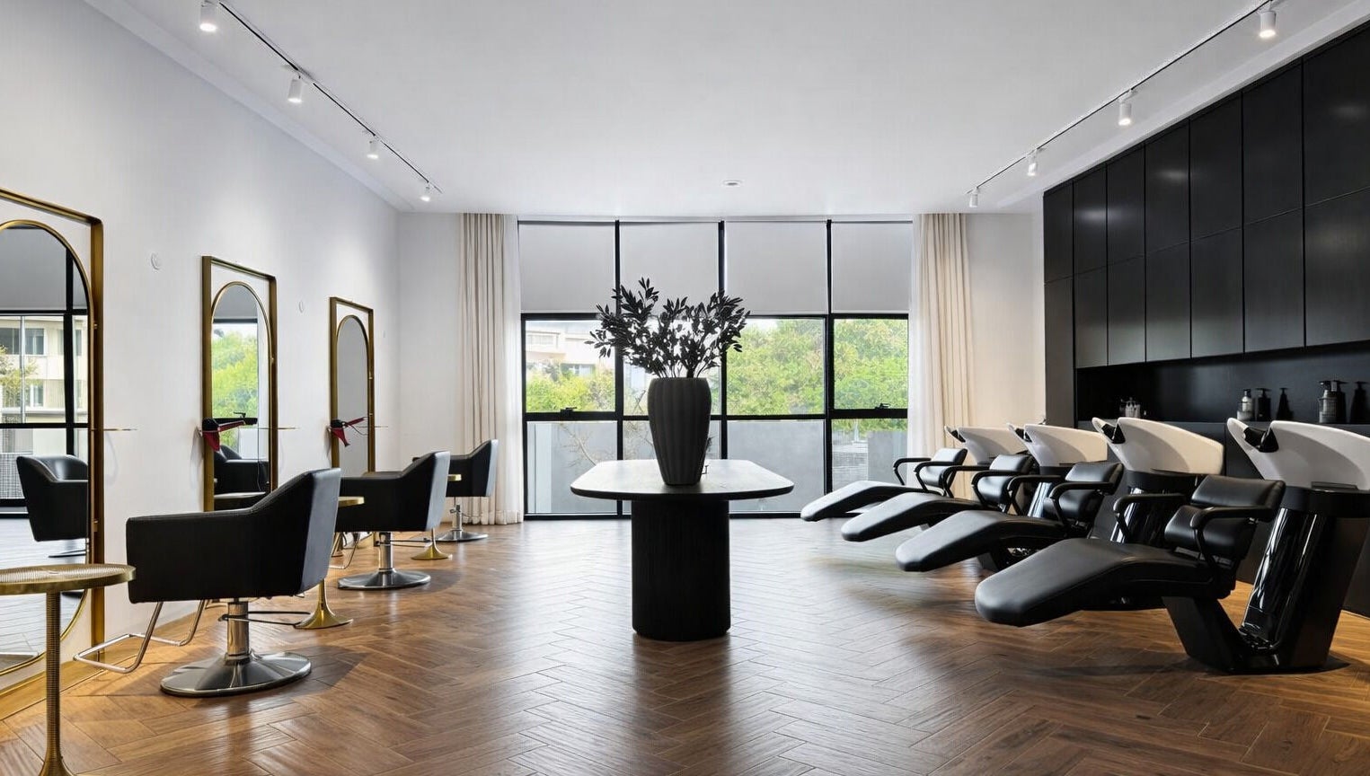 Modern interior of Mariage Beauty Center in Abu Dhabi, AE showcasing chic hair styling stations and wash basins.