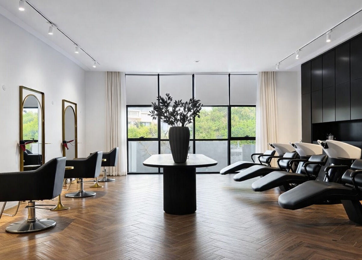 Modern interior of Mariage Beauty Center in Abu Dhabi, AE showcasing chic hair styling stations and wash basins.
