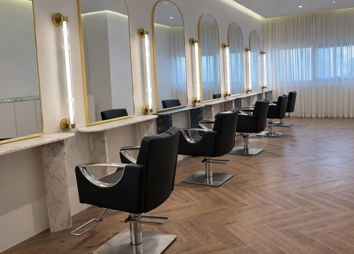 Elegant salon chairs in Mariage Beauty Center, Abu Dhabi, AE showcasing modern, well-lit styling stations.