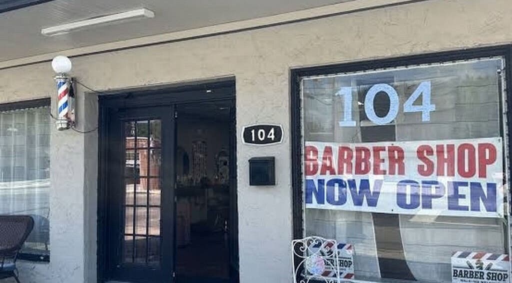 Entrance of Spackle Cuts, a newly opened barber shop at 104 Shipley, England, GB with welcoming sign.