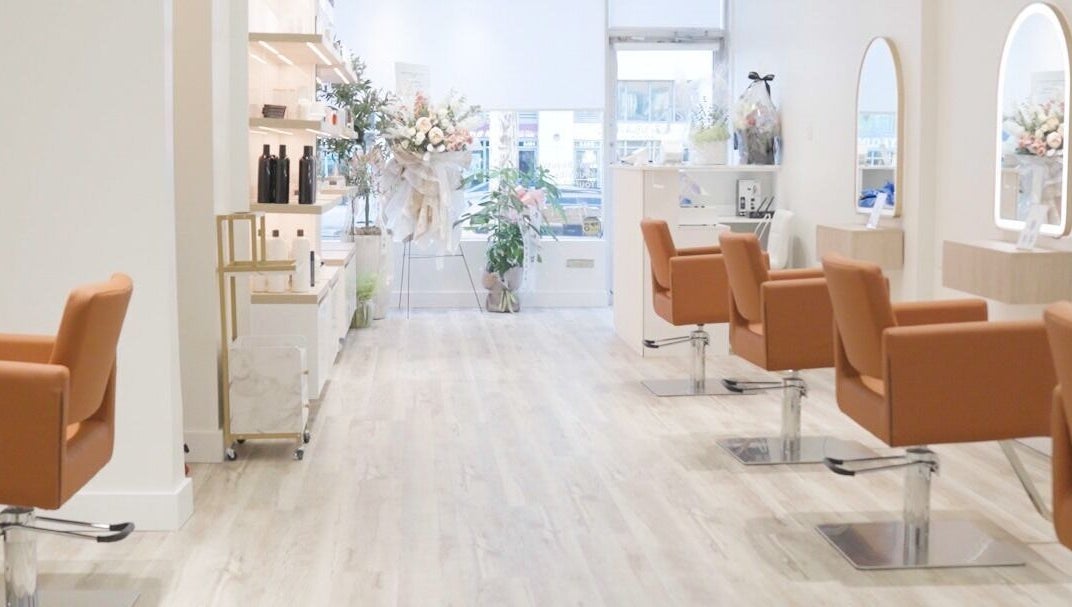Elegant interior of The Glam Hair&K Beauty salon in Toronto, Ontario, CA with stylish seating and decor.