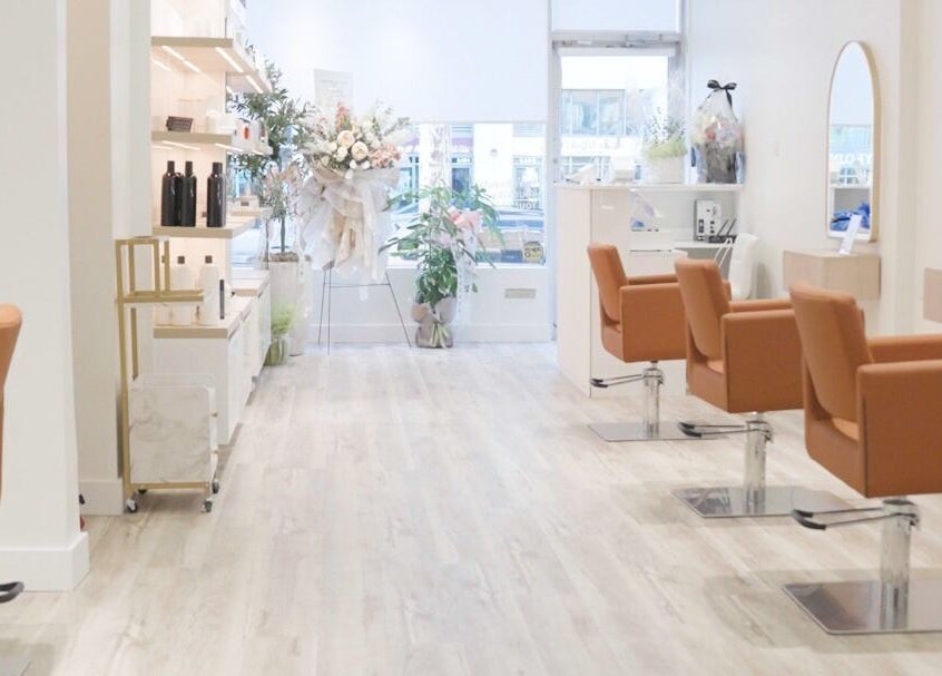 Elegant interior of The Glam Hair&K Beauty salon in Toronto, Ontario, CA with stylish seating and decor.