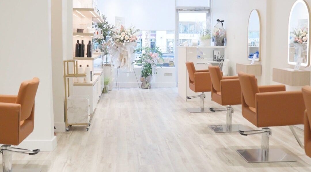 Elegant interior of The Glam Hair&K Beauty salon in Toronto, Ontario, CA with stylish seating and decor.