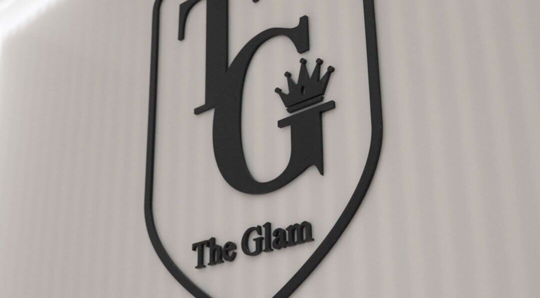 The Glam Hair&K Beauty logo wall at Toronto, Ontario, CA showcasing elegant branding.