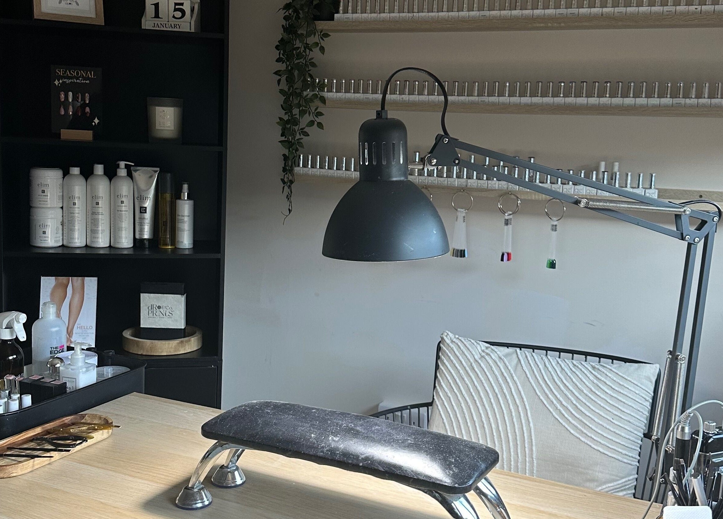 Modern nail treatment setup at Shape & Gloss in Stoke-on-Trent, England, GB. Includes lamp, tools, and products.
