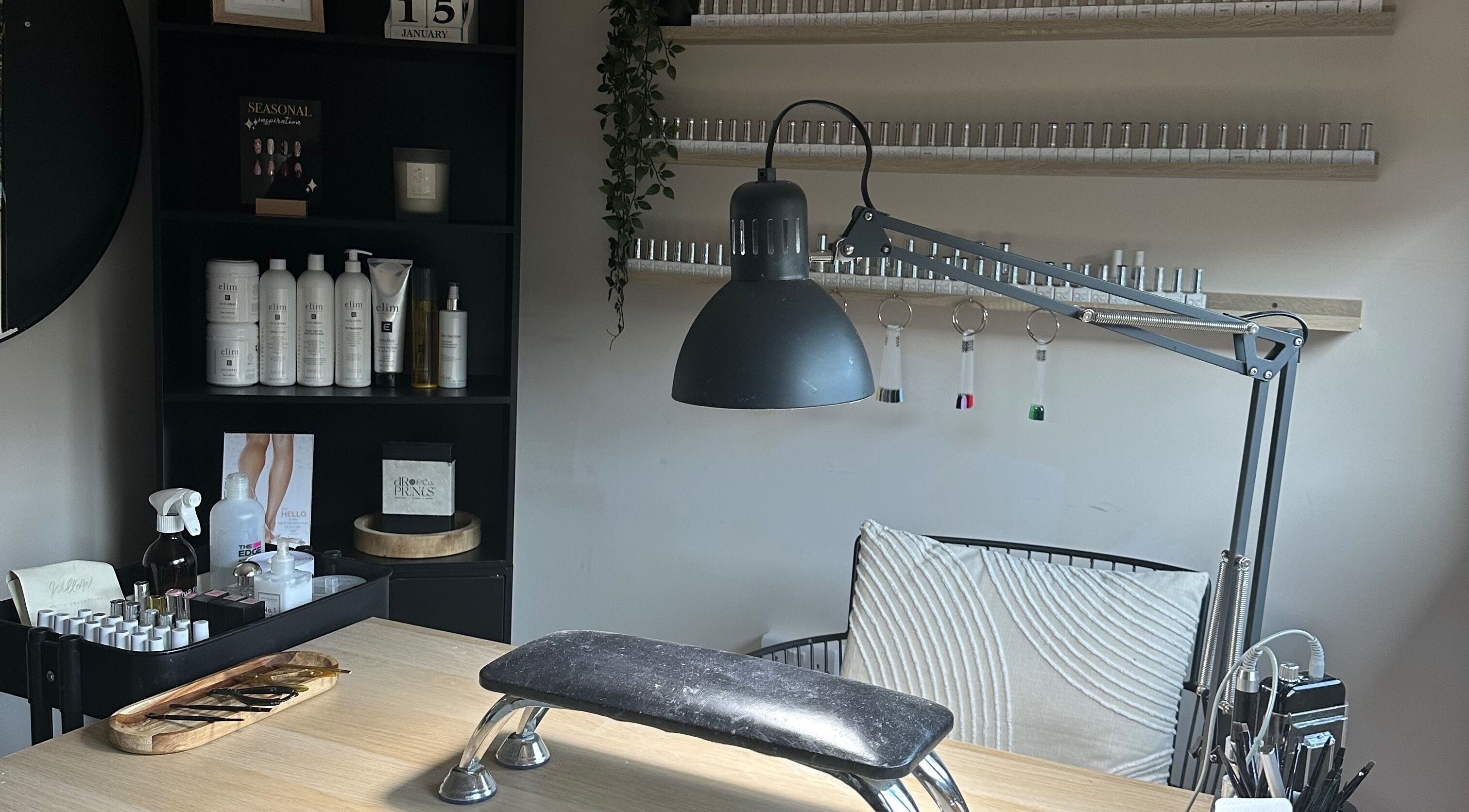 Modern nail treatment setup at Shape & Gloss in Stoke-on-Trent, England, GB. Includes lamp, tools, and products.