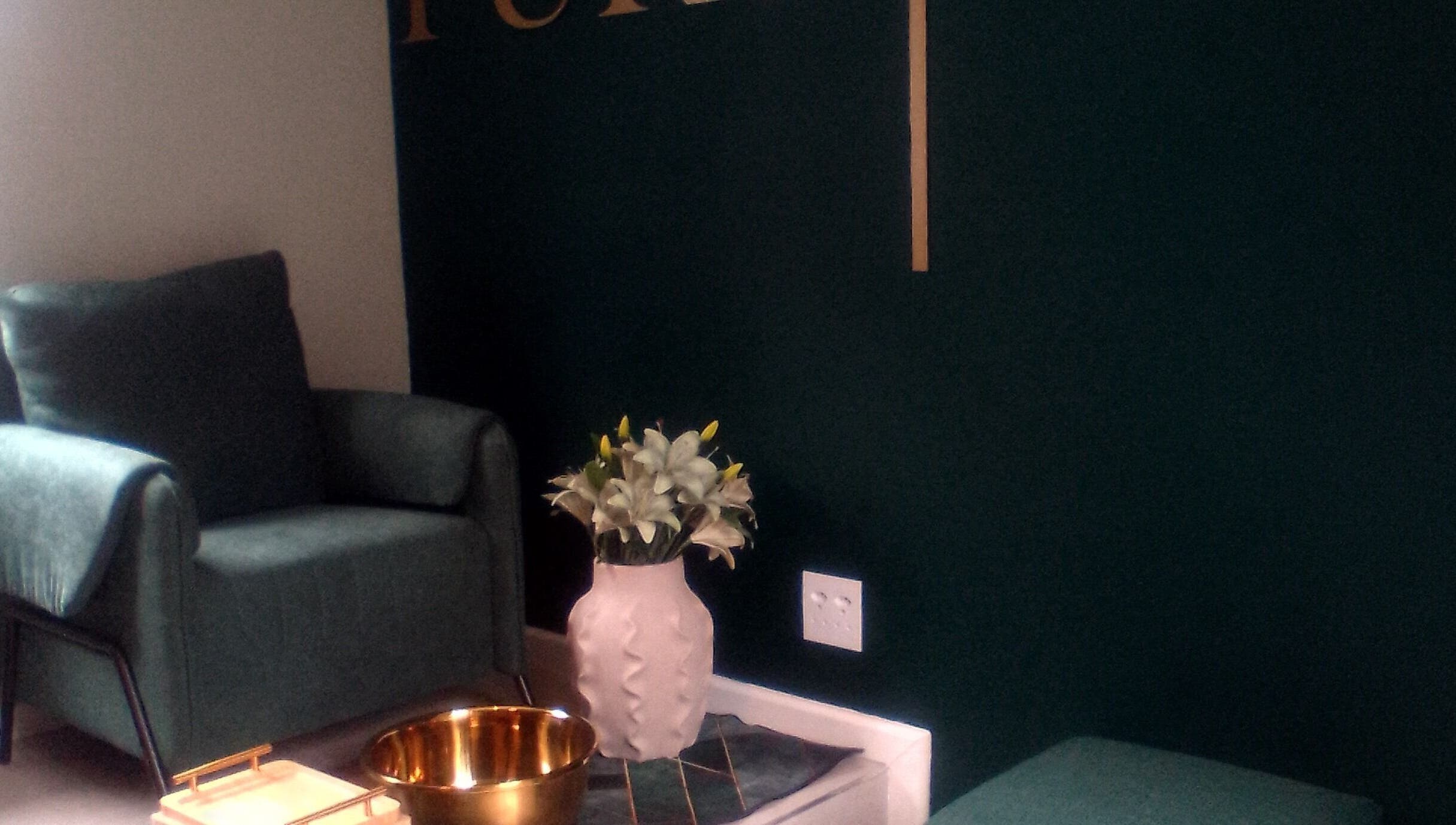 Inviting lounge area at PURE GLAM (Port Elizabeth), Gqeberha, Eastern Cape, ZA, with stylish seating and decor.