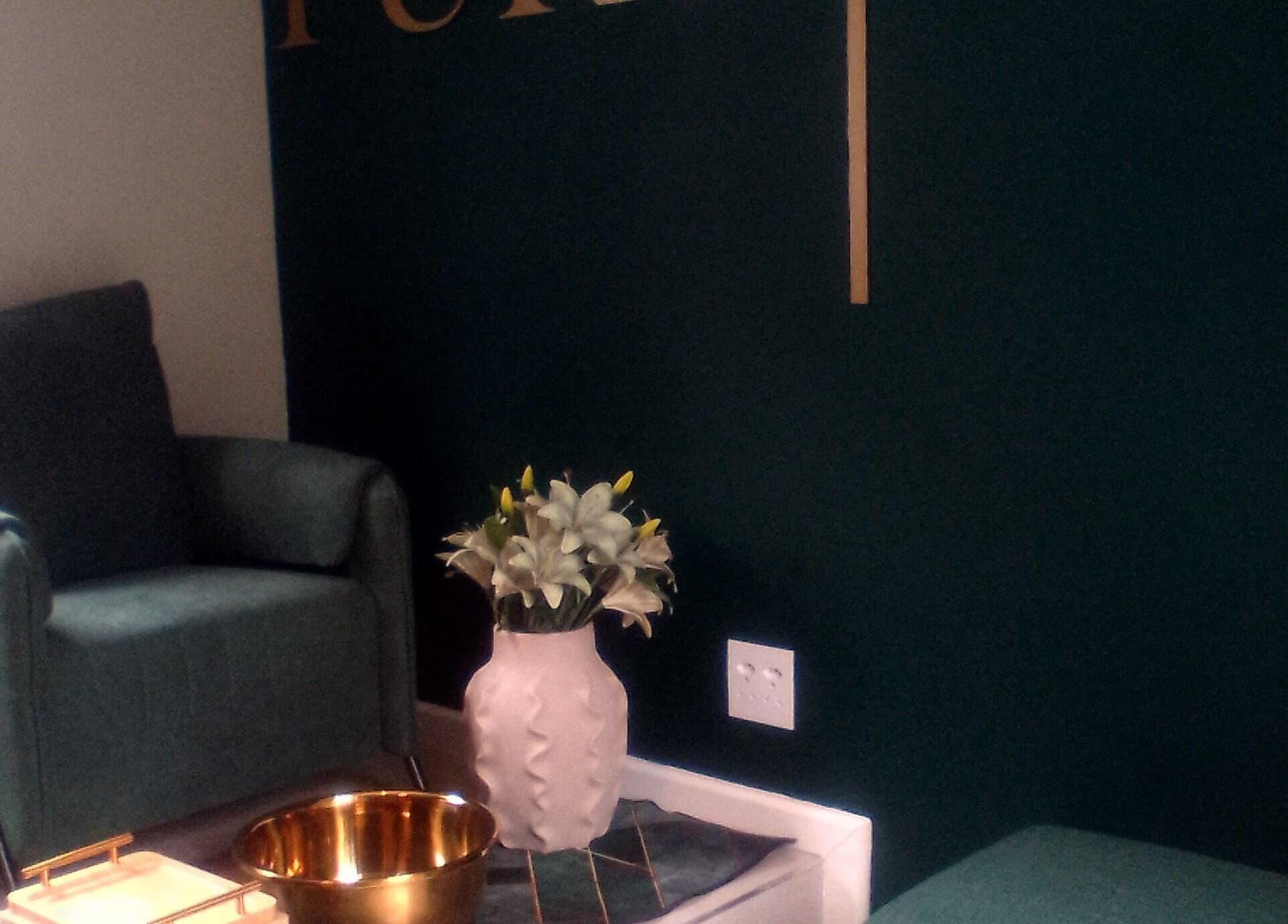 Inviting lounge area at PURE GLAM (Port Elizabeth), Gqeberha, Eastern Cape, ZA, with stylish seating and decor.