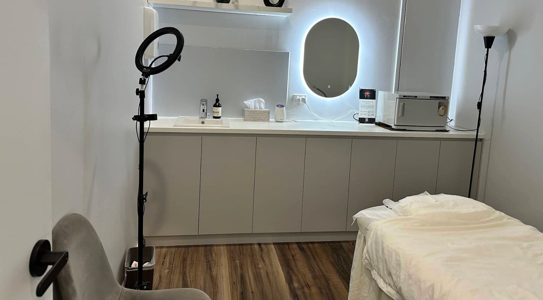 Relaxing treatment room at Beauty One Aesthetics, Melbourne, Victoria, AU with spa bed and modern decor.