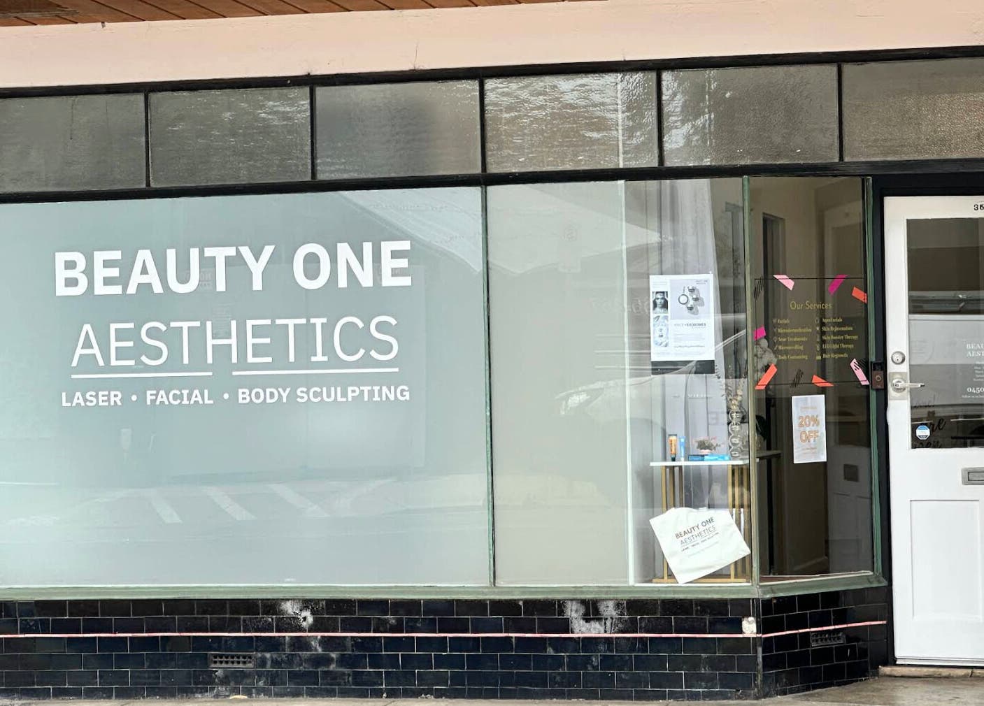 Front view of Beauty One Aesthetics in Melbourne, Victoria, AU with signage for laser, facial, and body sculpting.