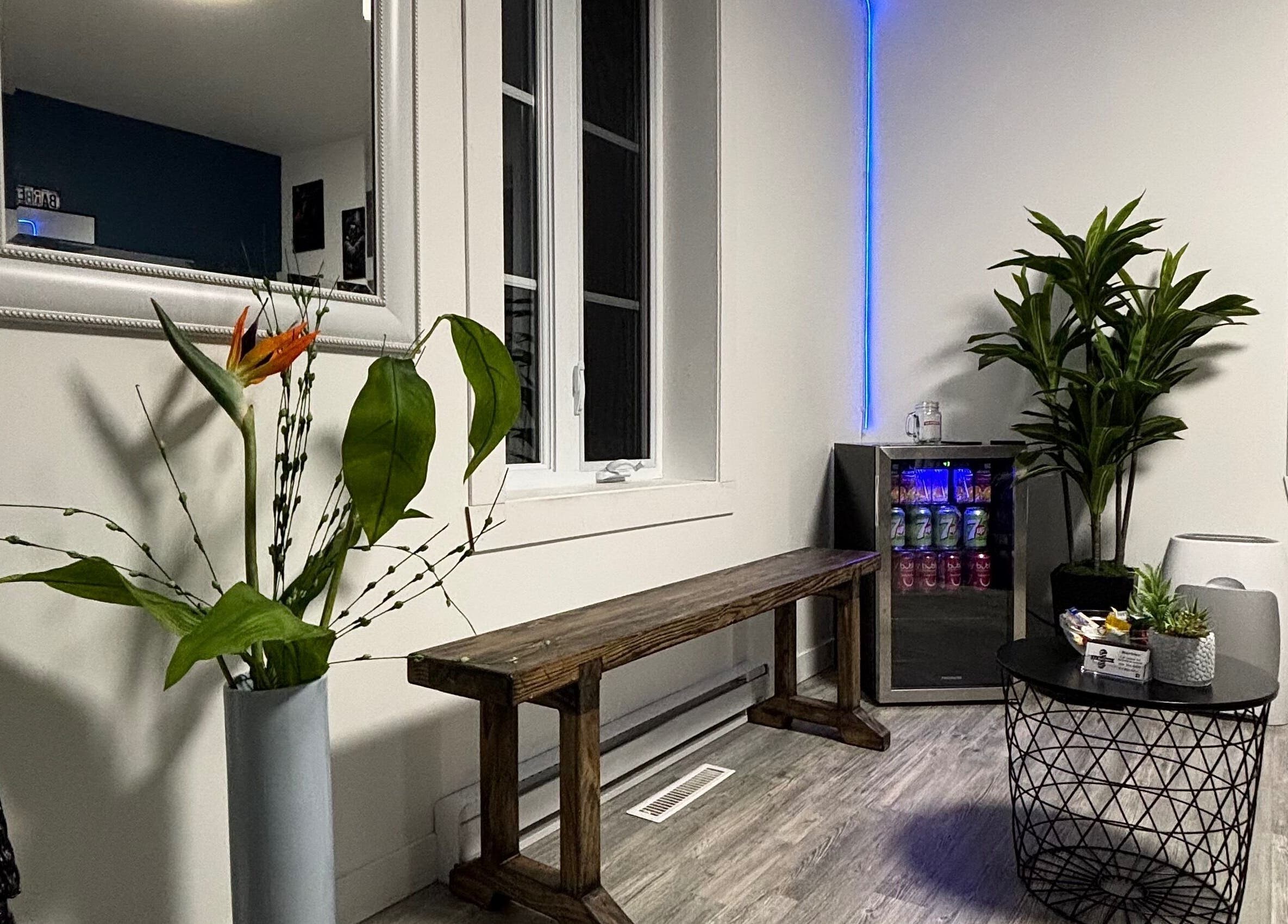 Relaxing seating area at La Bar.bière, Saint-cyrille-de-lessard, Québec, CA with plants and ambient lighting.