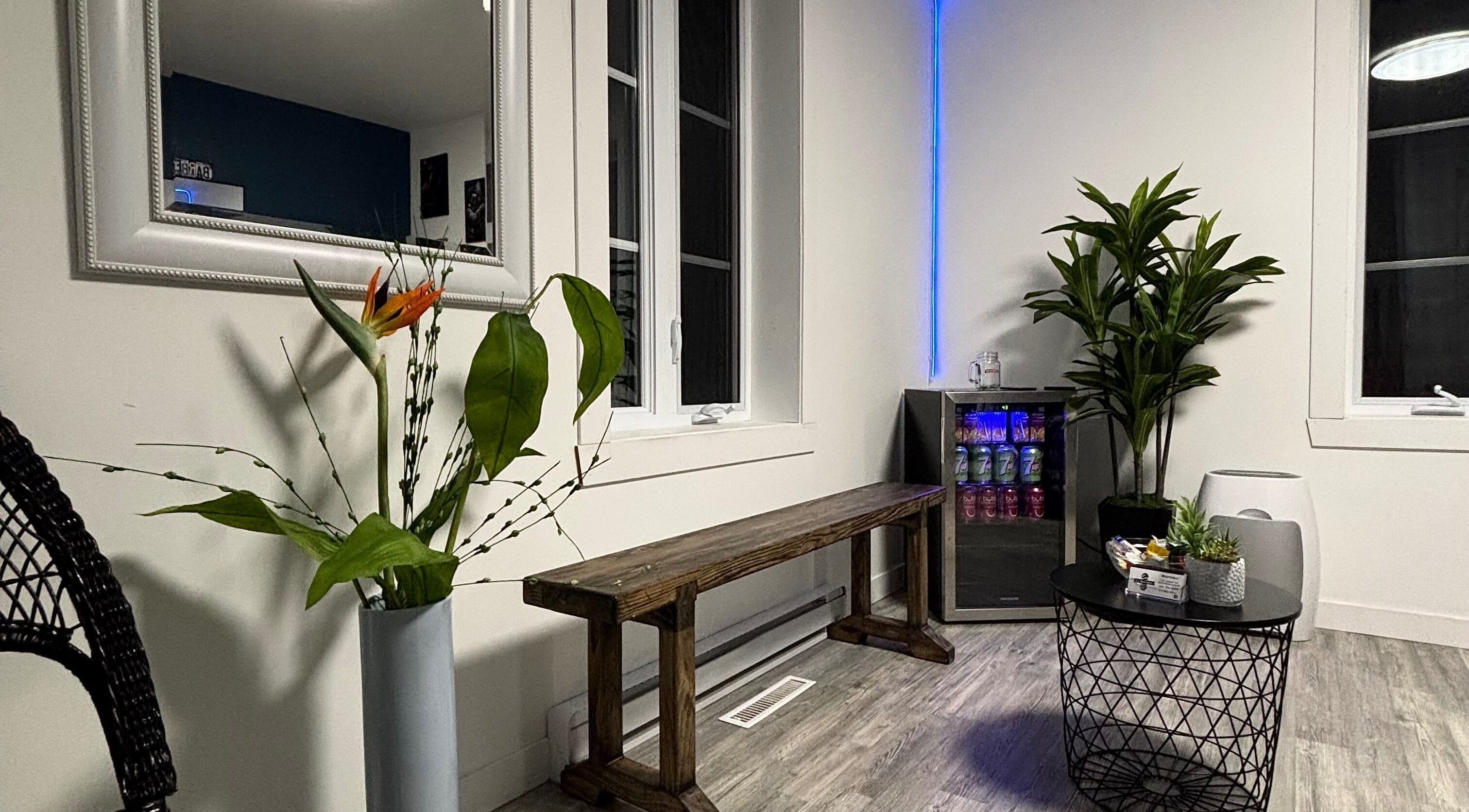 Relaxing seating area at La Bar.bière, Saint-cyrille-de-lessard, Québec, CA with plants and ambient lighting.
