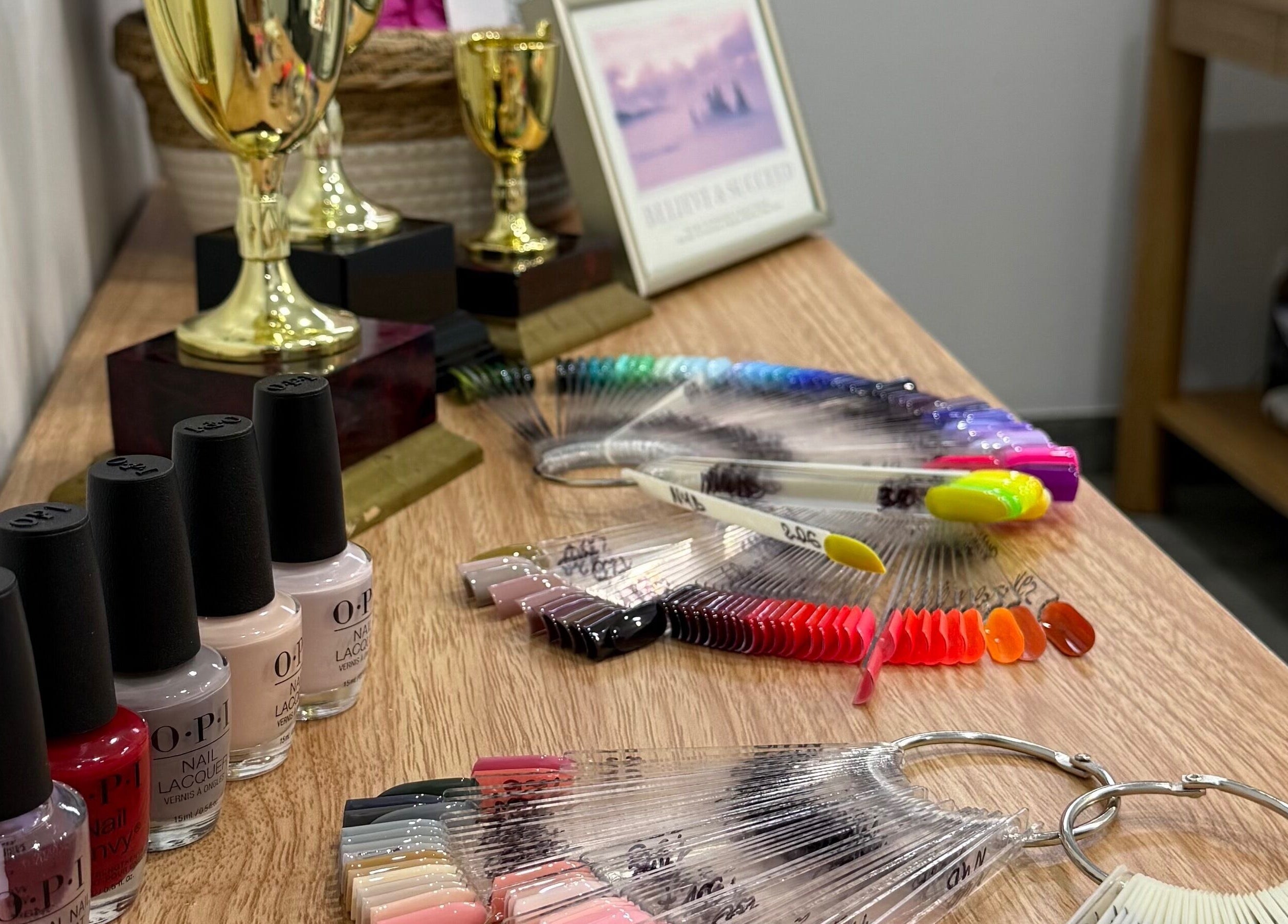 Nail polish and trophies at Amazing Nails by Anna, Bexley, New South Wales, AU showcasing vibrant colors.