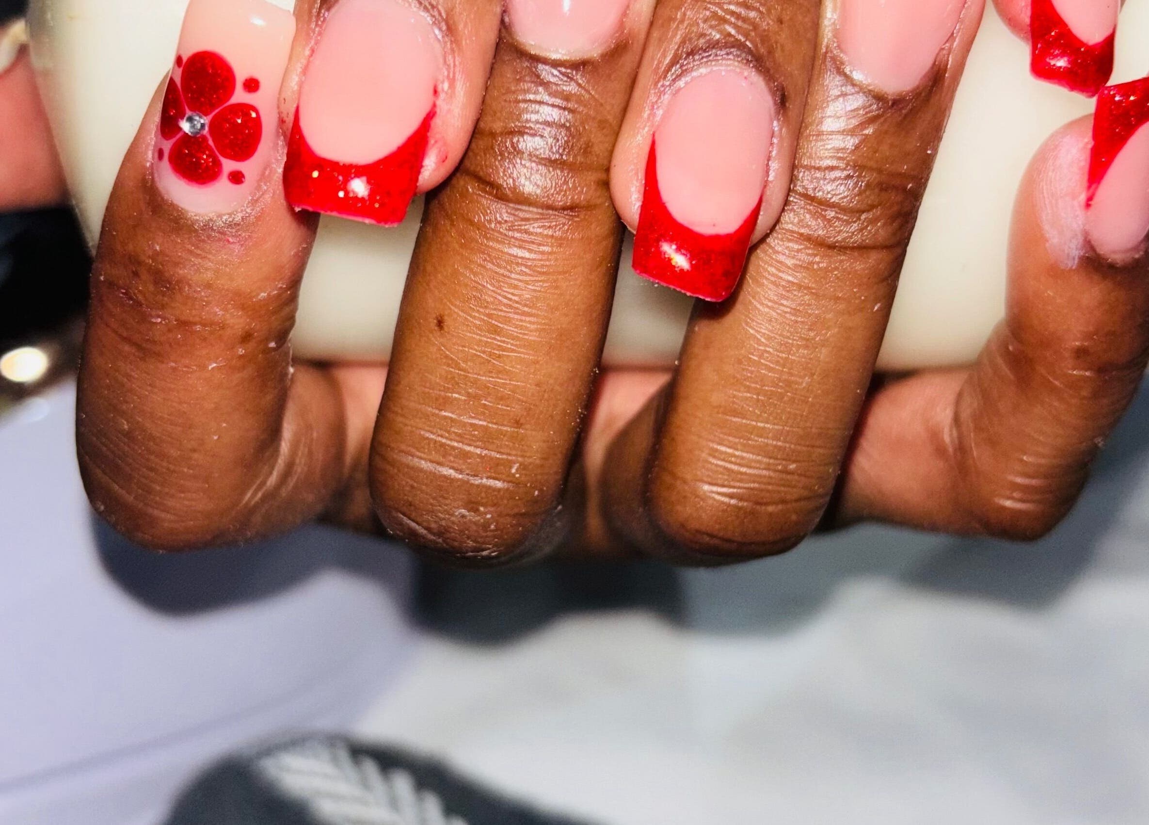 Red and pink nail art by Nails by Nelz in Alberton, Gauteng, ZA enhancing a client's hand.
