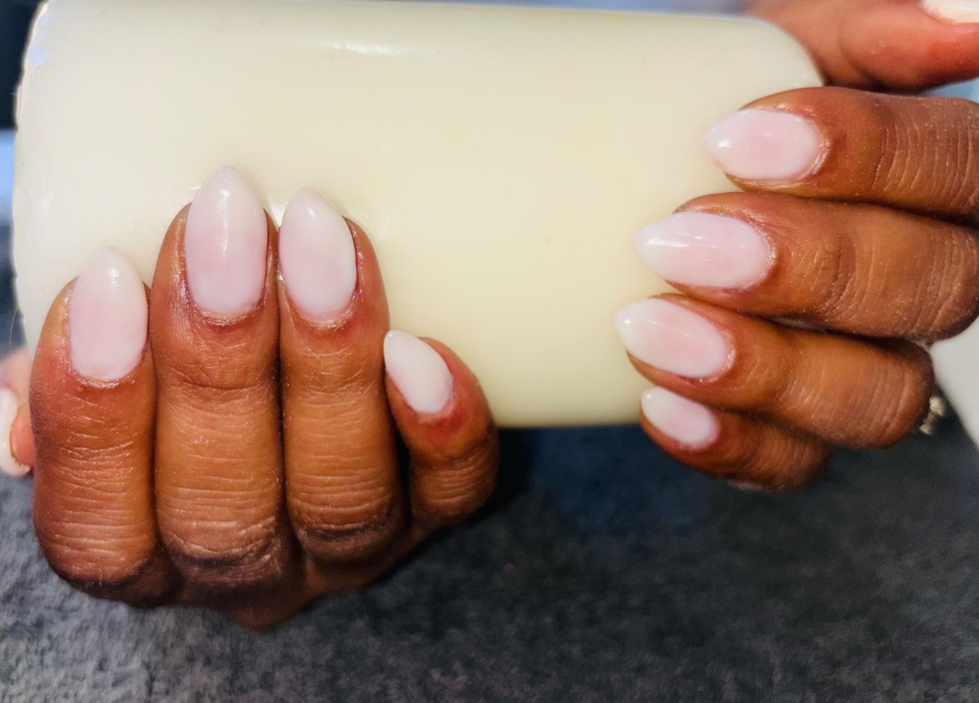 Pink manicured nails holding a candle at Nails by Nelz, Alberton, Gauteng, ZA.