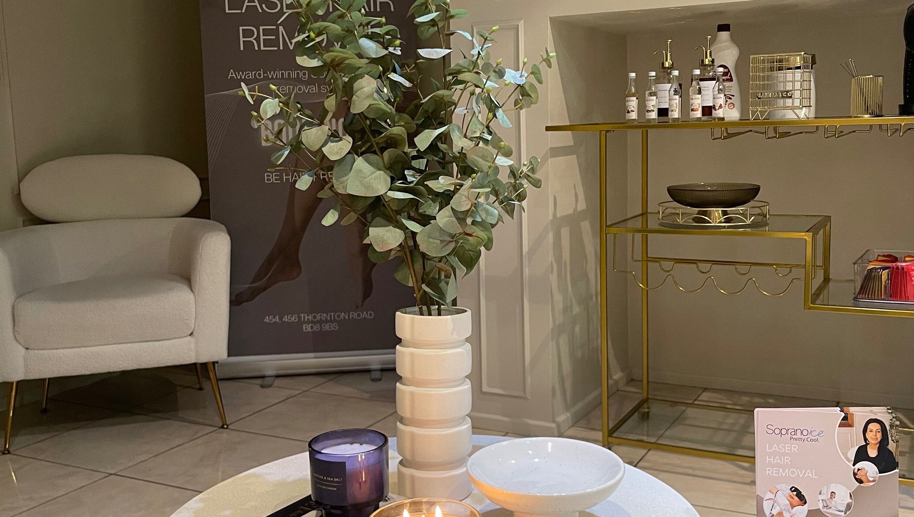 Modern waiting area at Aiylashes, Bradford, England, GB, featuring stylish decor and promotional materials.