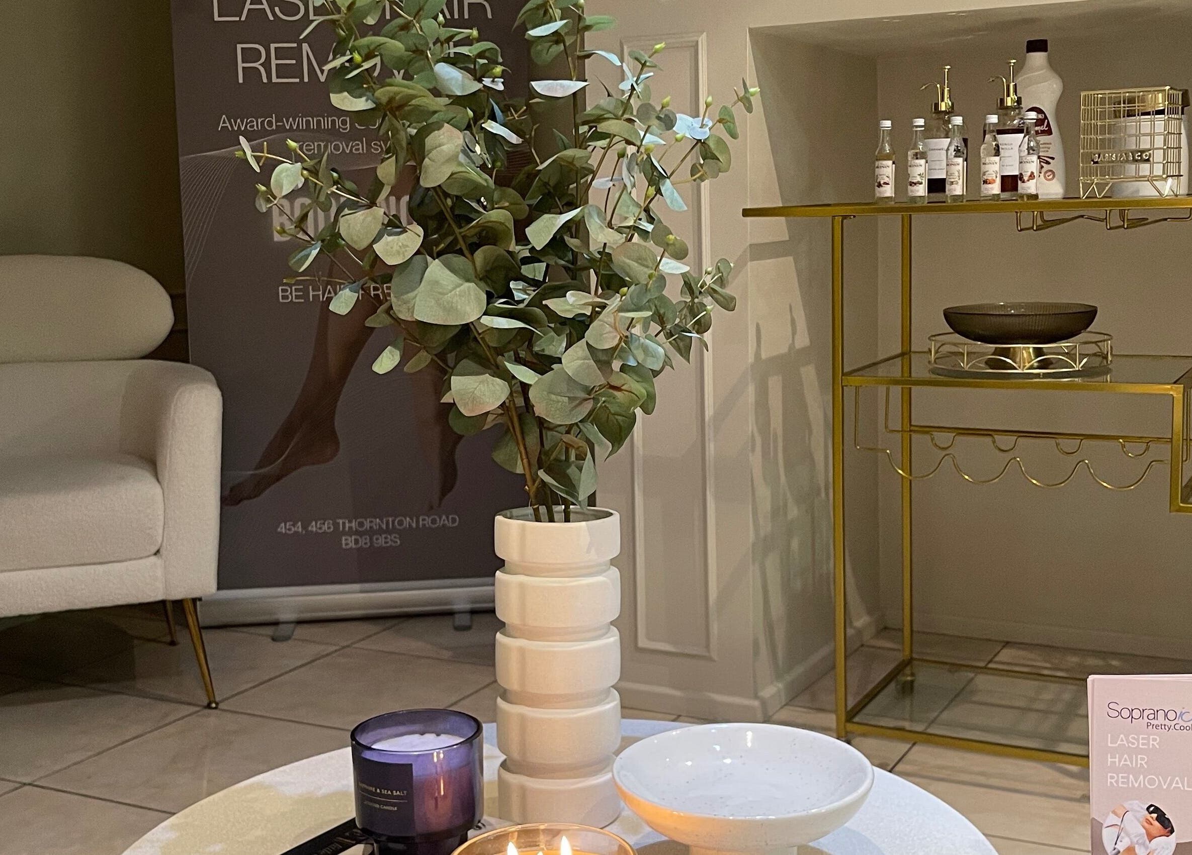 Modern waiting area at Aiylashes, Bradford, England, GB, featuring stylish decor and promotional materials.