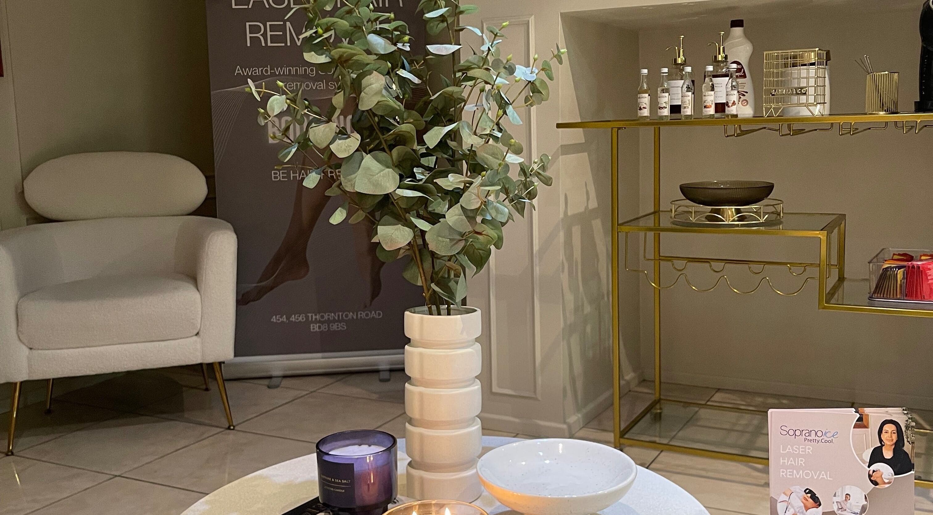 Modern waiting area at Aiylashes, Bradford, England, GB, featuring stylish decor and promotional materials.