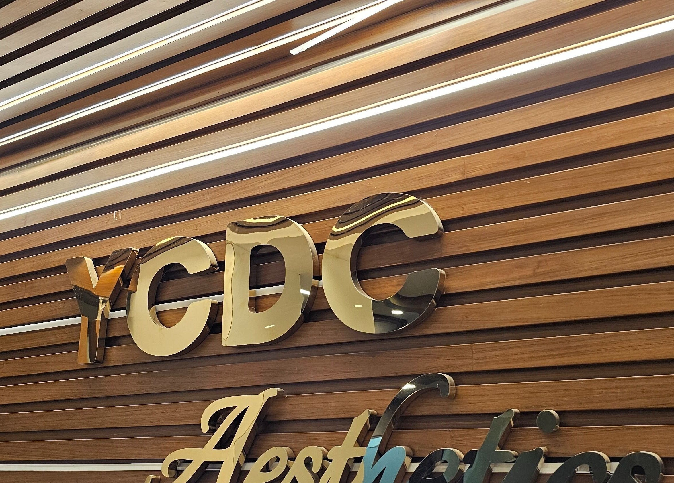YCDC THERAPISTS logo on polished wood in Bengaluru, Karnataka, IN, showcasing the venue's elegance.
