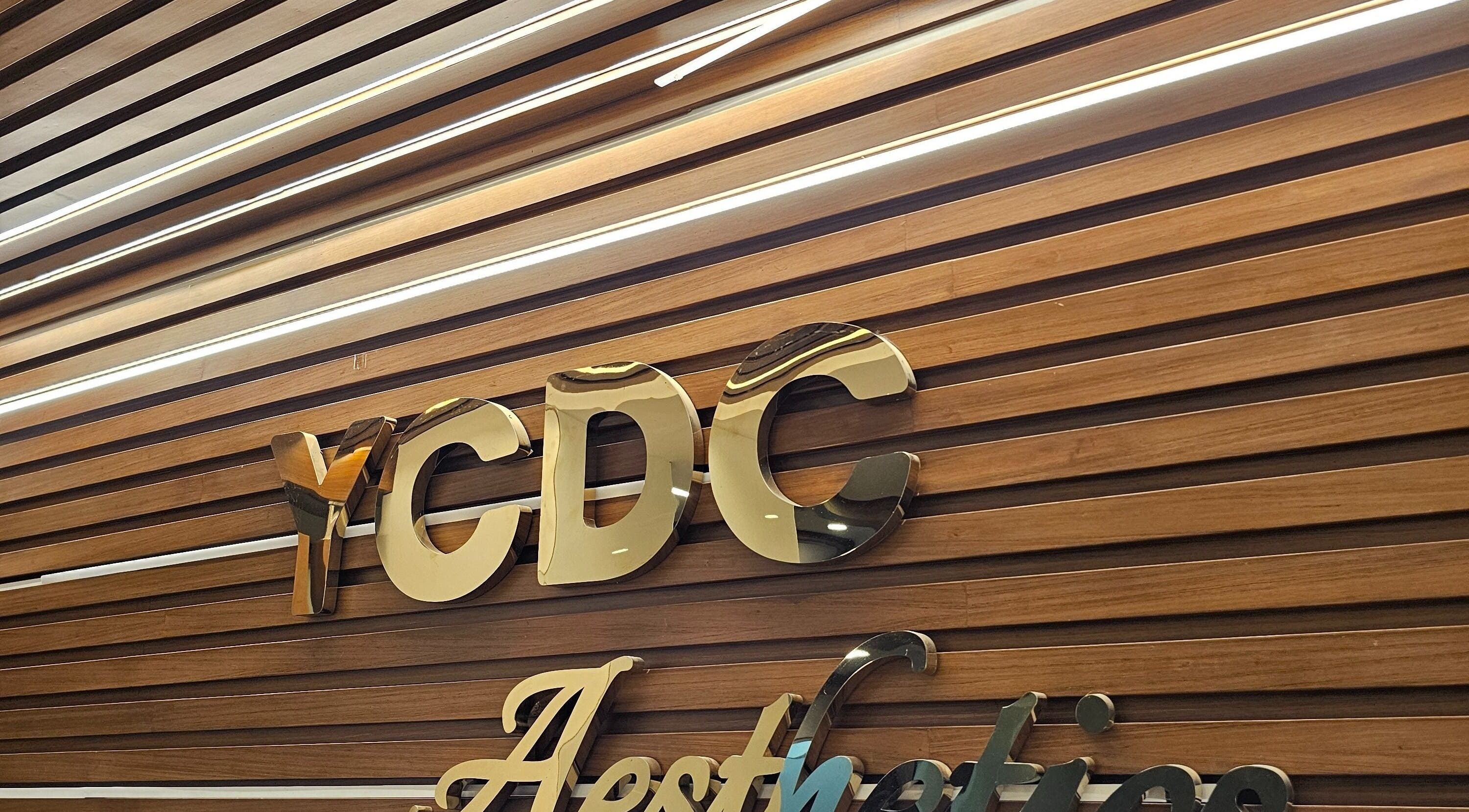YCDC THERAPISTS logo on polished wood in Bengaluru, Karnataka, IN, showcasing the venue's elegance.