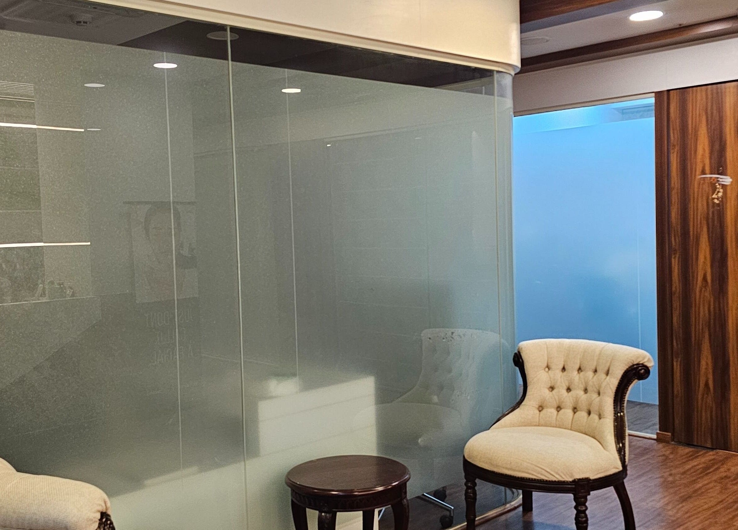 Cozy seating area at YCDC THERAPISTS, Bengaluru, Karnataka, IN with elegant chairs and glass partition.