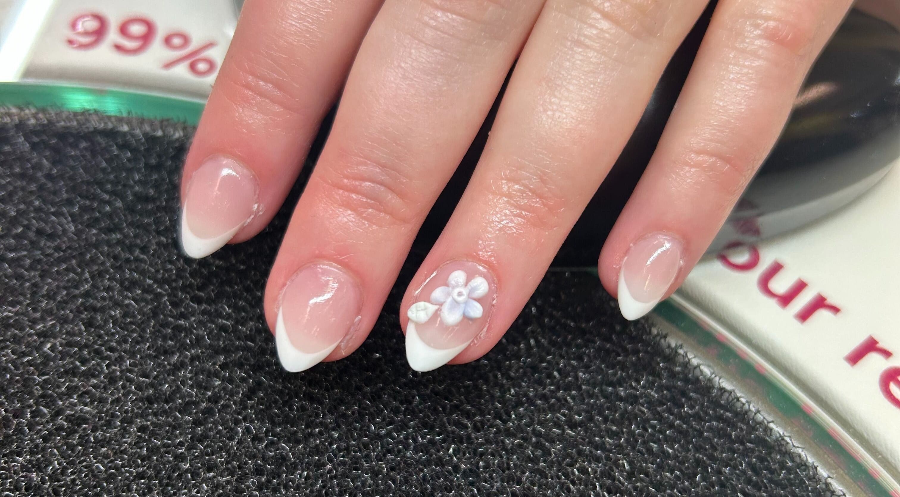 Elegant French tips with floral design at Vinyls & Varnish Beauty Studio, Perth, Tasmania, AU.