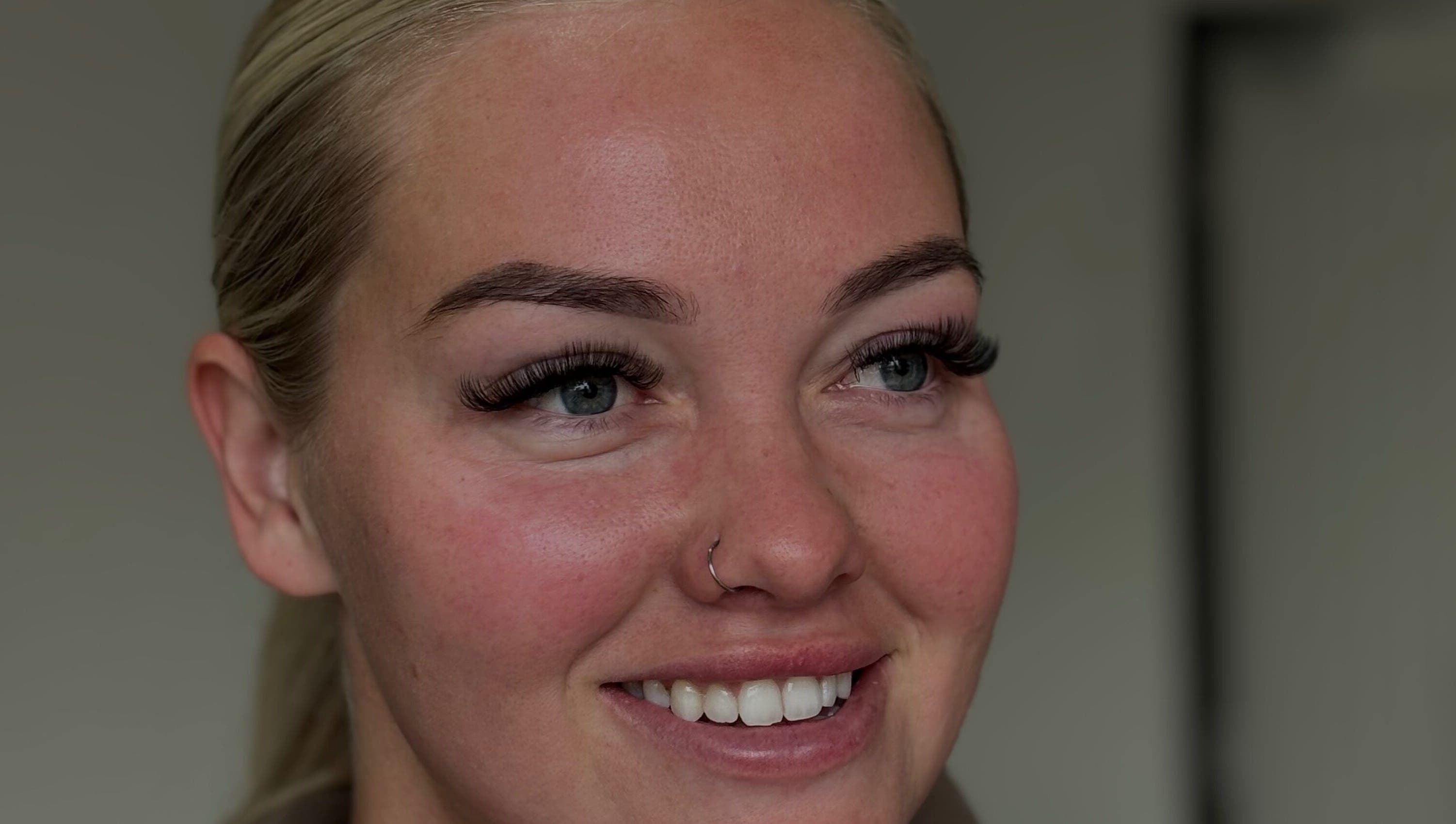 Smiling woman with enhanced eyelashes at with.jodes, Newhaven, England, GB showcasing beauty services.