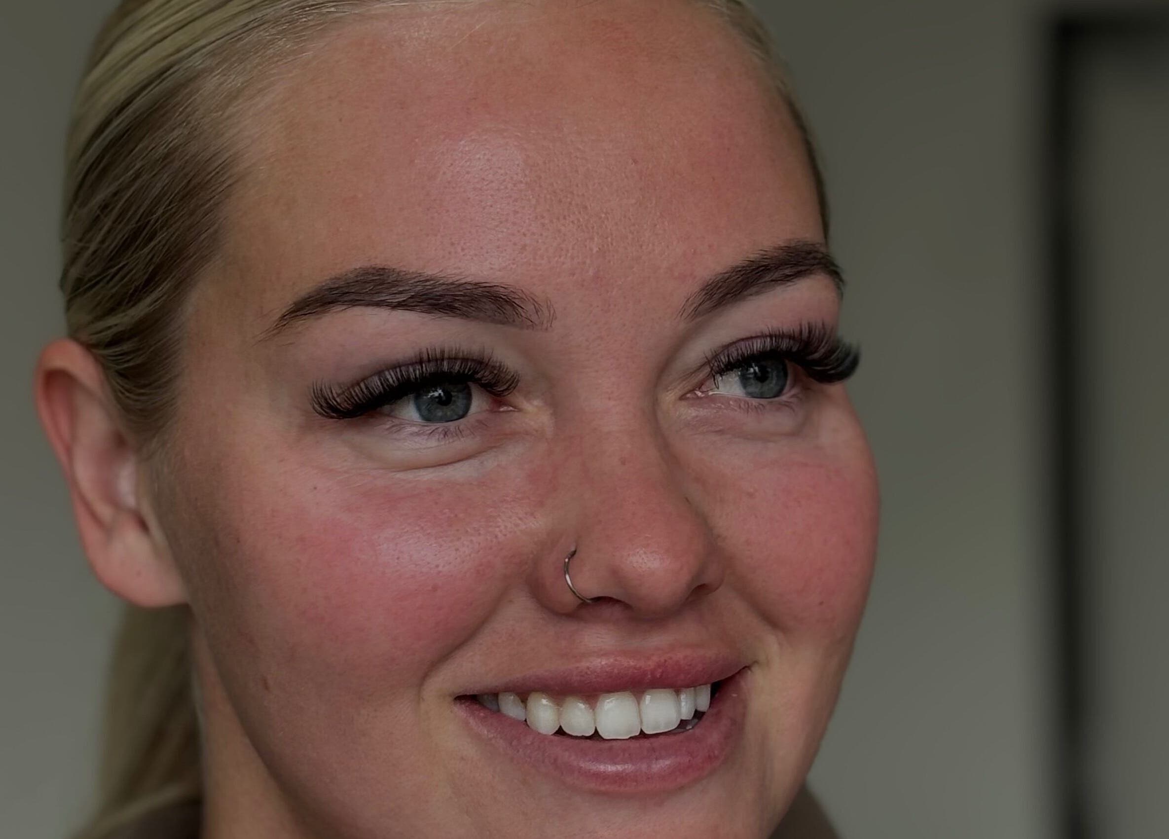 Smiling woman with enhanced eyelashes at with.jodes, Newhaven, England, GB showcasing beauty services.