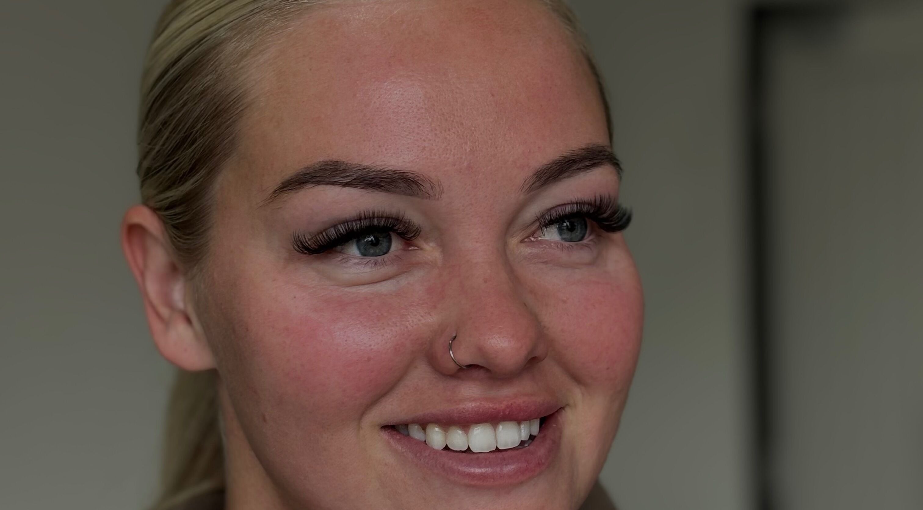 Smiling woman with enhanced eyelashes at with.jodes, Newhaven, England, GB showcasing beauty services.