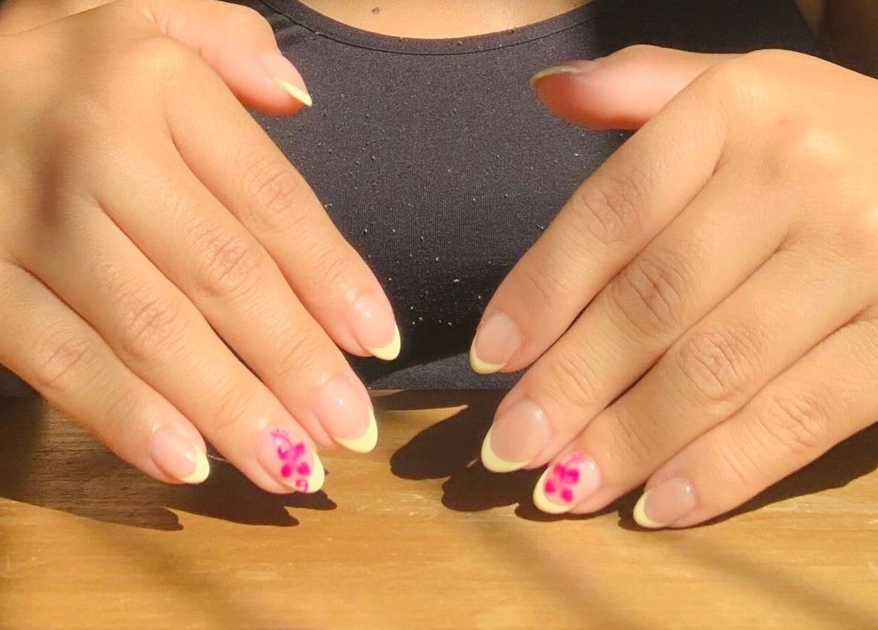 Perfectly manicured hands with floral designs at Ash Beauty Collective, Cape Town, Western Cape, ZA.